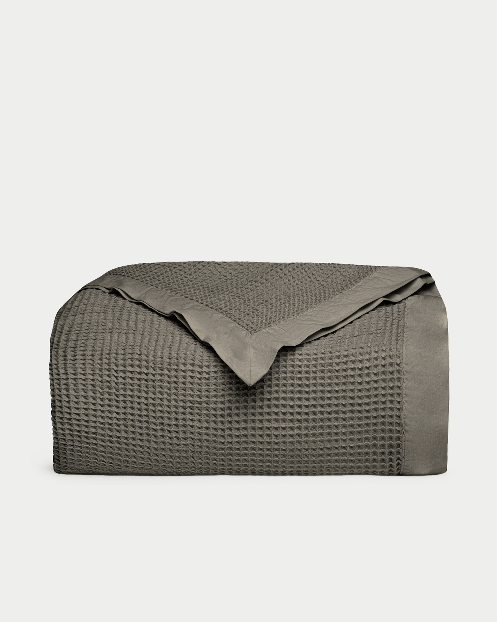 Charcoal waffle blanket folded with plain white background