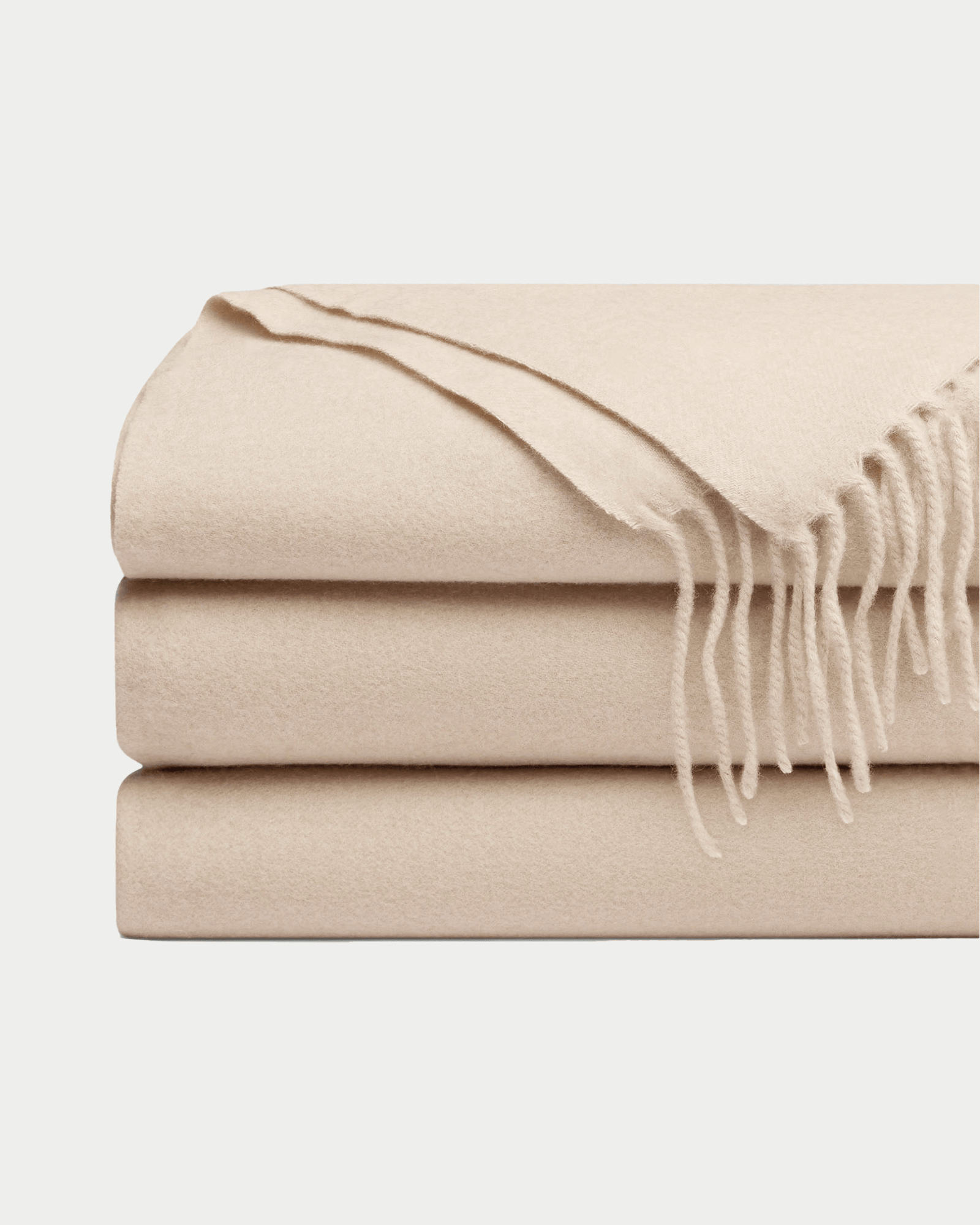 Dune cashmere tassel throw folded with white background 