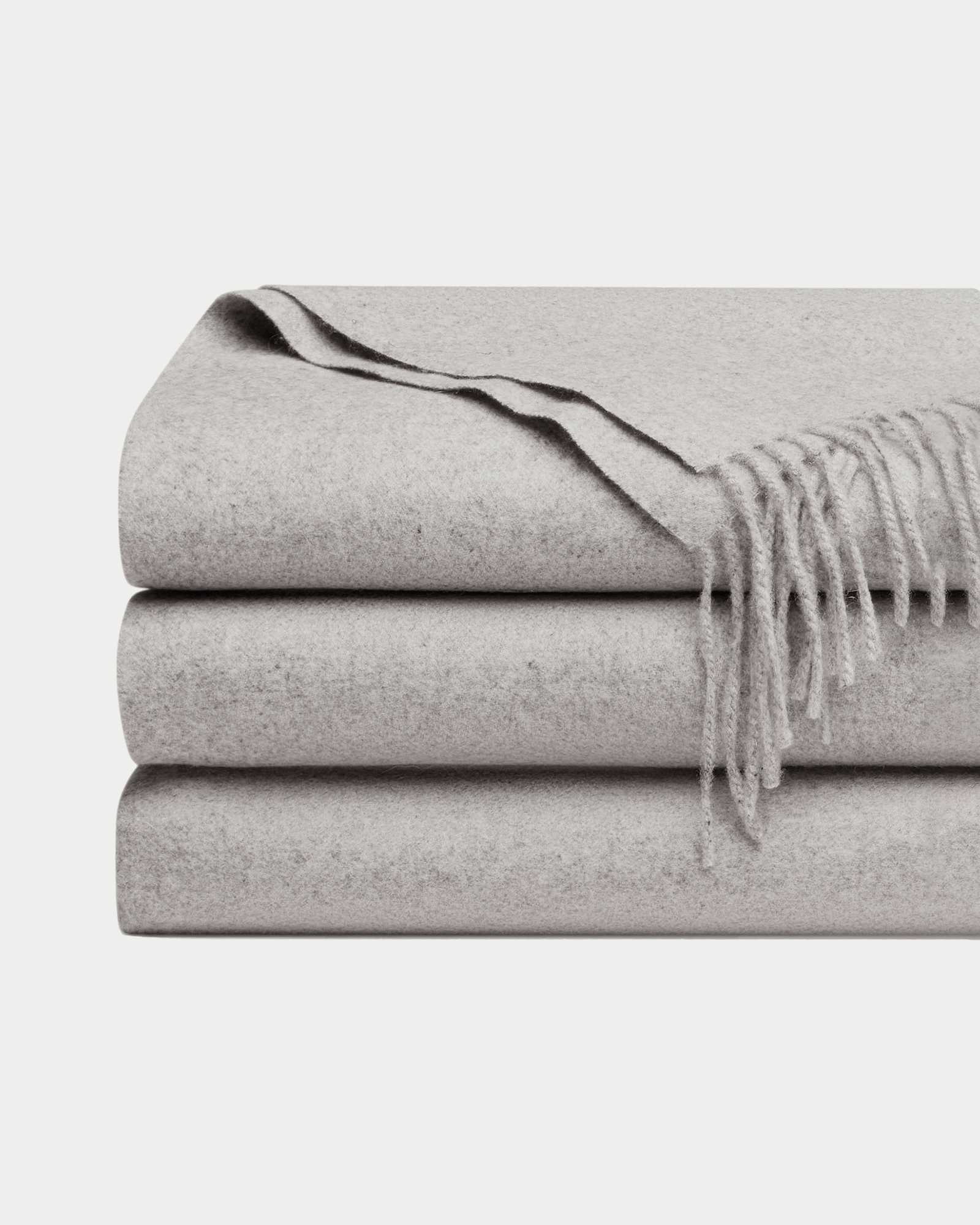 Pebble cashmere tassel throw folded with white background 