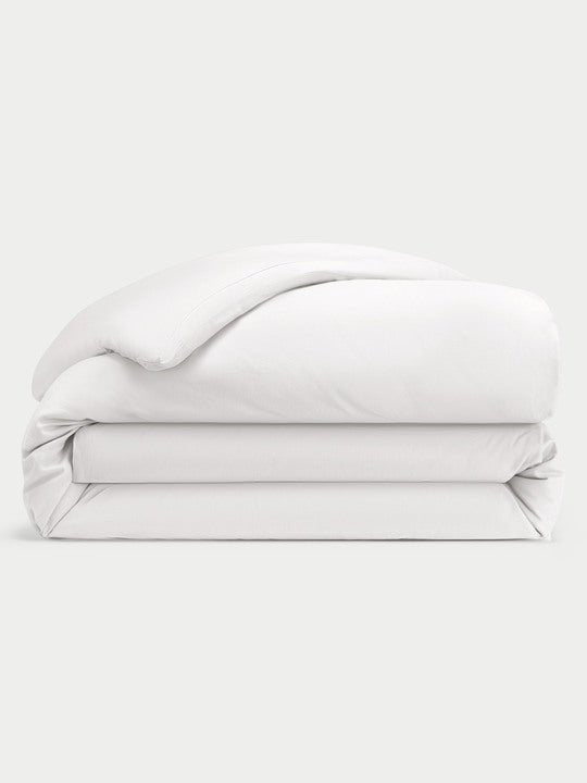 White Linen Duvet Cover neatly folded over white background.