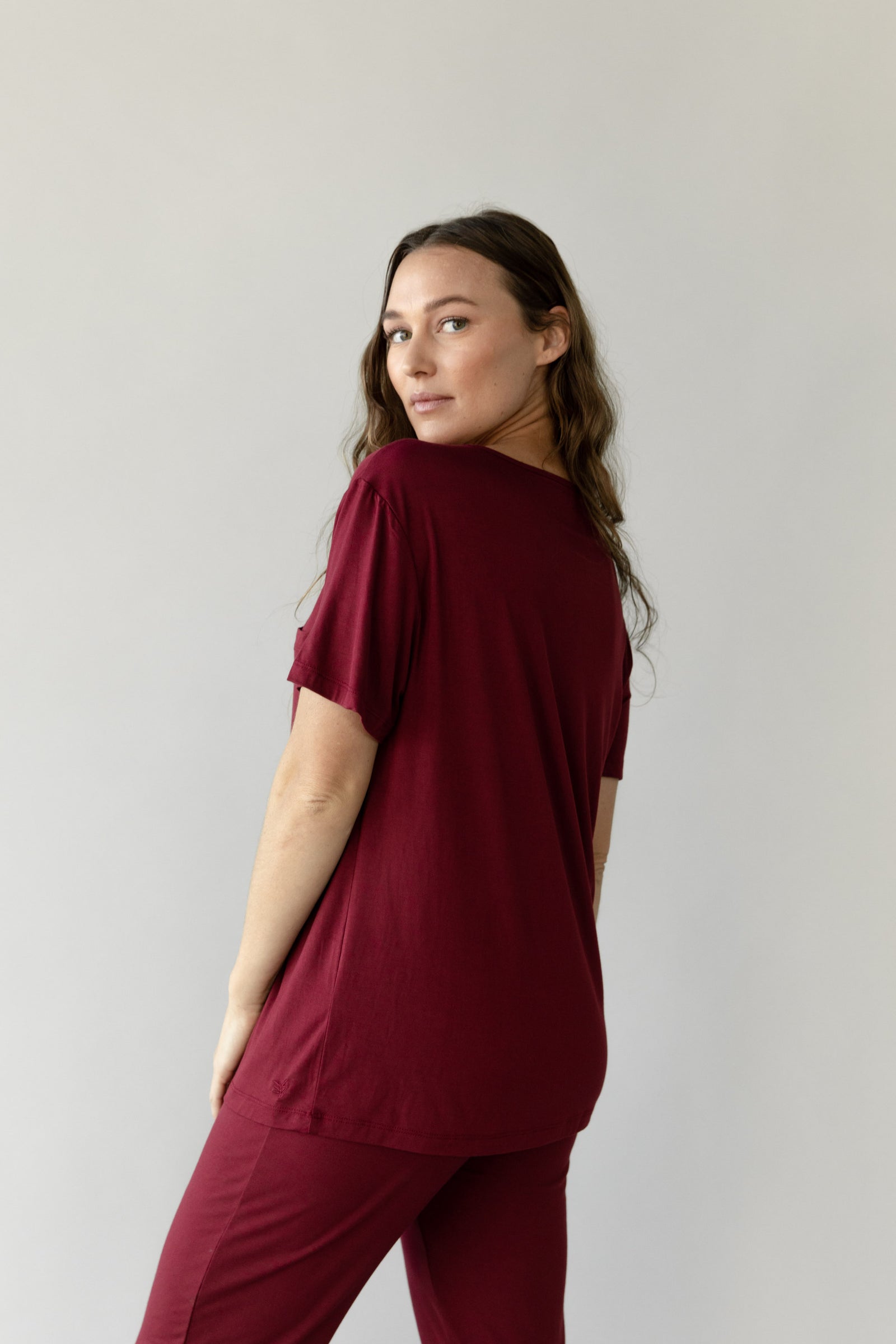 Woman wearing Cozy Earth Bamboo Lounge Tee in dark burgundy