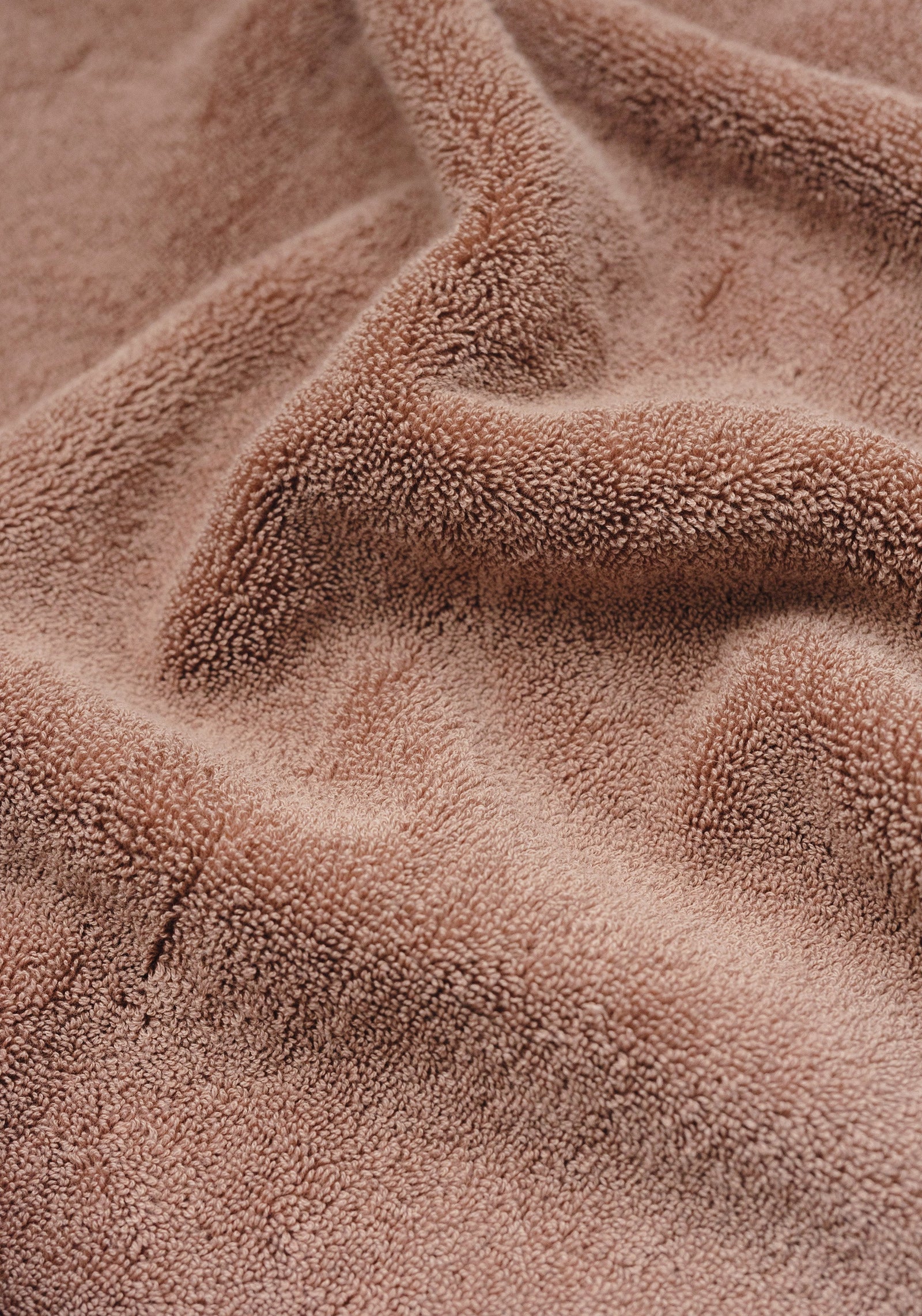 Premium Plush Bath Towel in the color Clay. Photo of Clay Premium Plush Bath Towel taken as a close up only showing the Premium Plush Bath Towel's texture