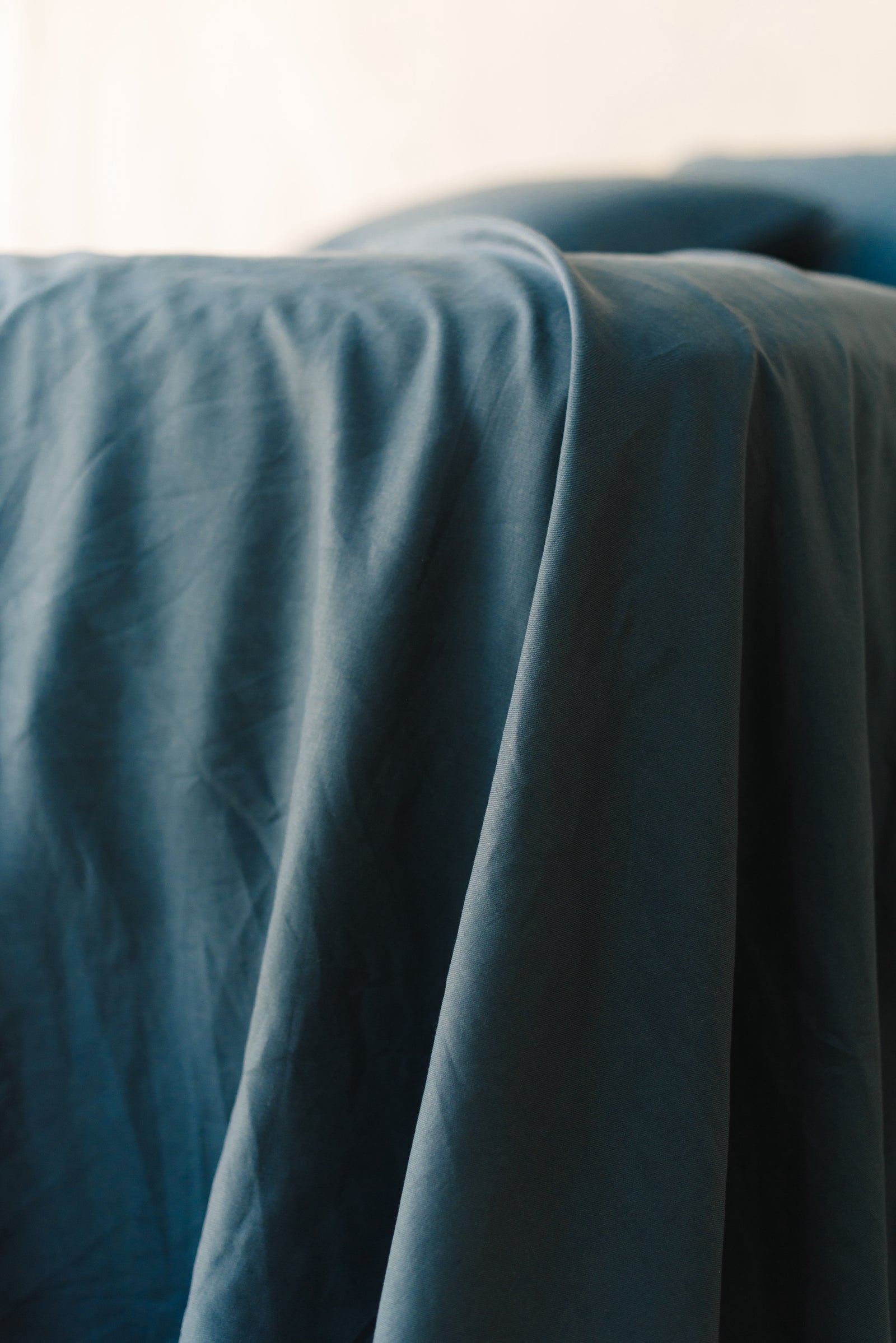 Navy Linen Bamboo Fitted Sheet on bed.