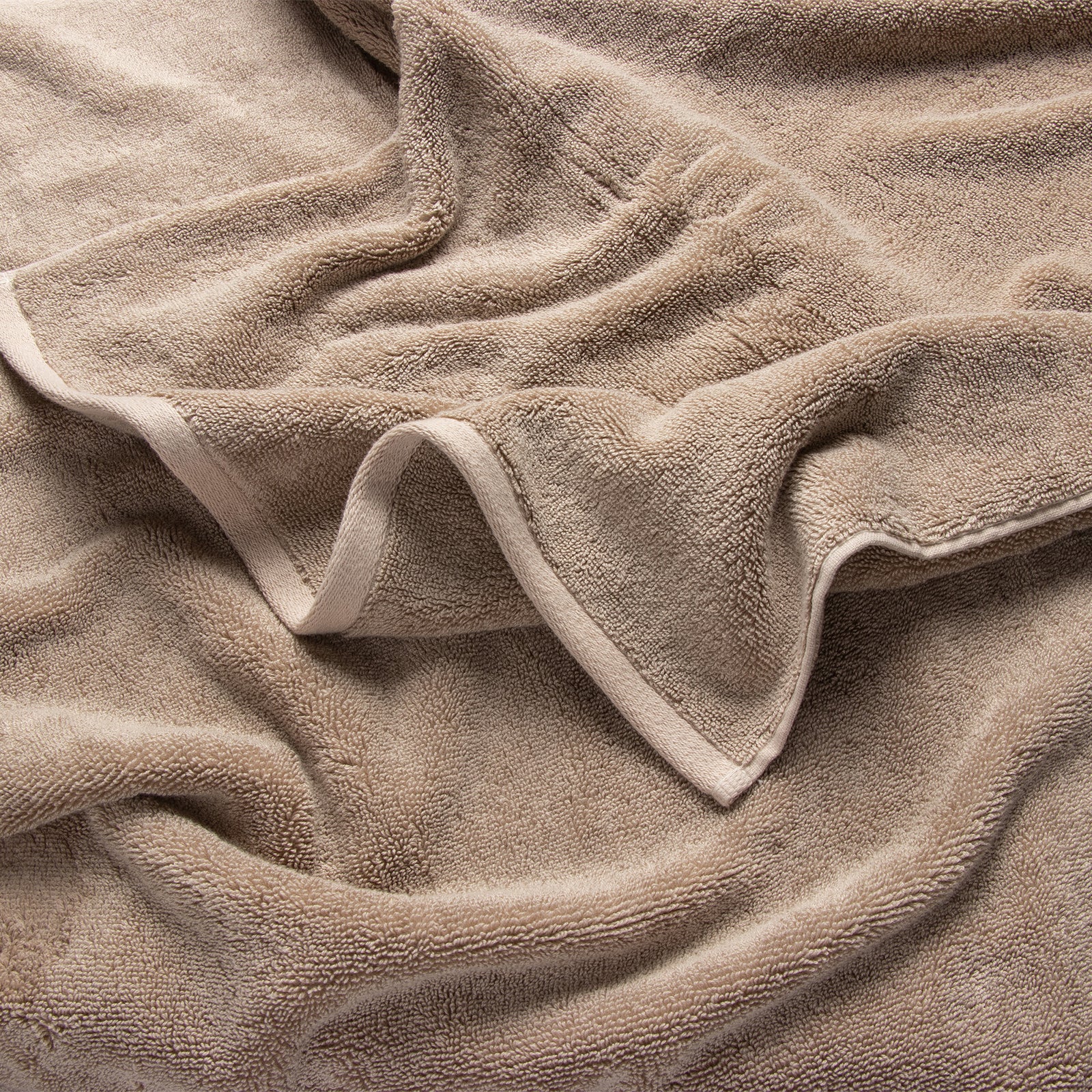 Premium Plush Bath Towel in the color Sand. Photo of Sand Premium Plush Bath Towel taken as a close up only showing the Premium Plush Bath Towel's texture
