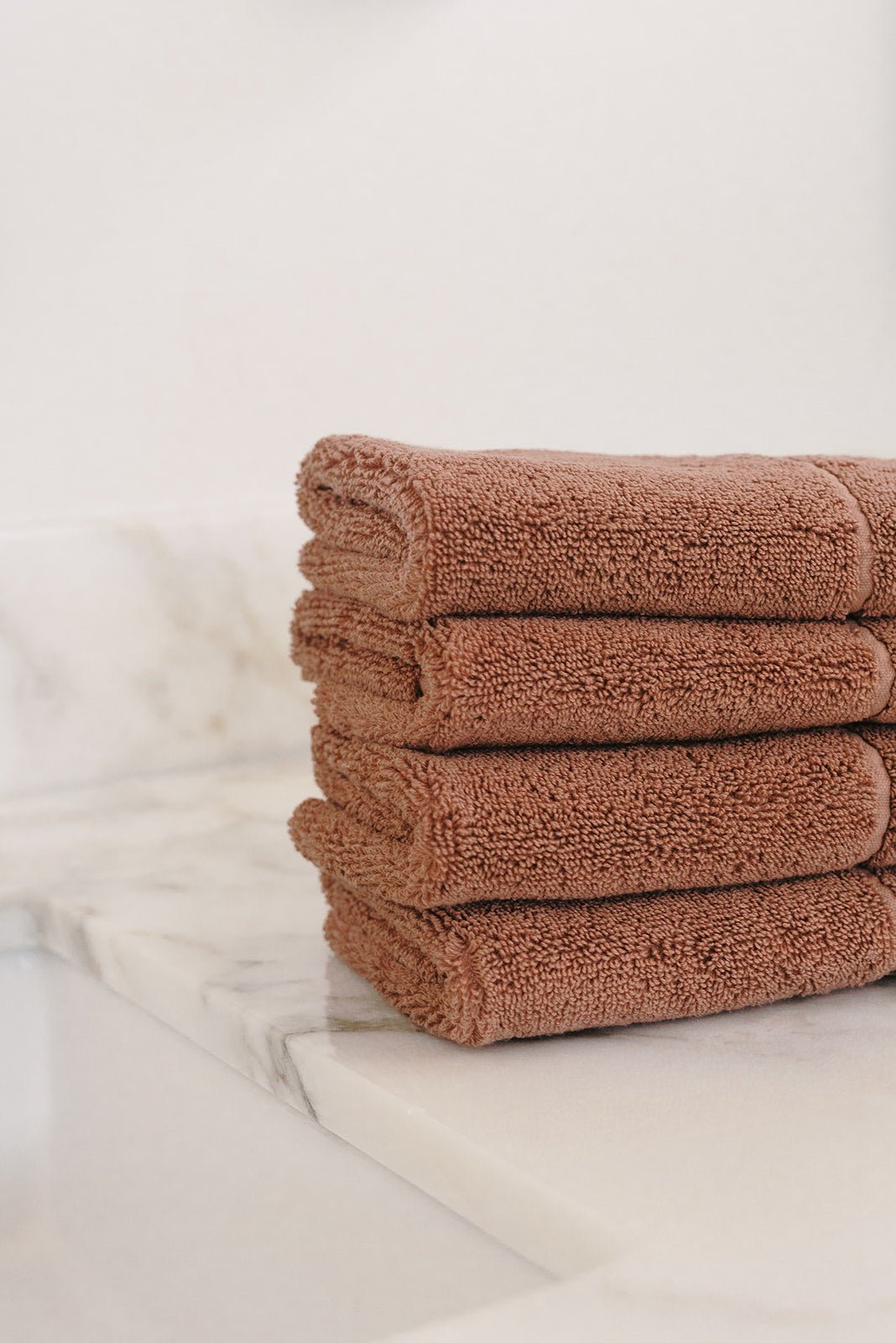 Charcoal Premium Plush Wash Cloths. Photo of Premium Plush Wash Cloths taken with in a white bathroom with marble counter tops. 