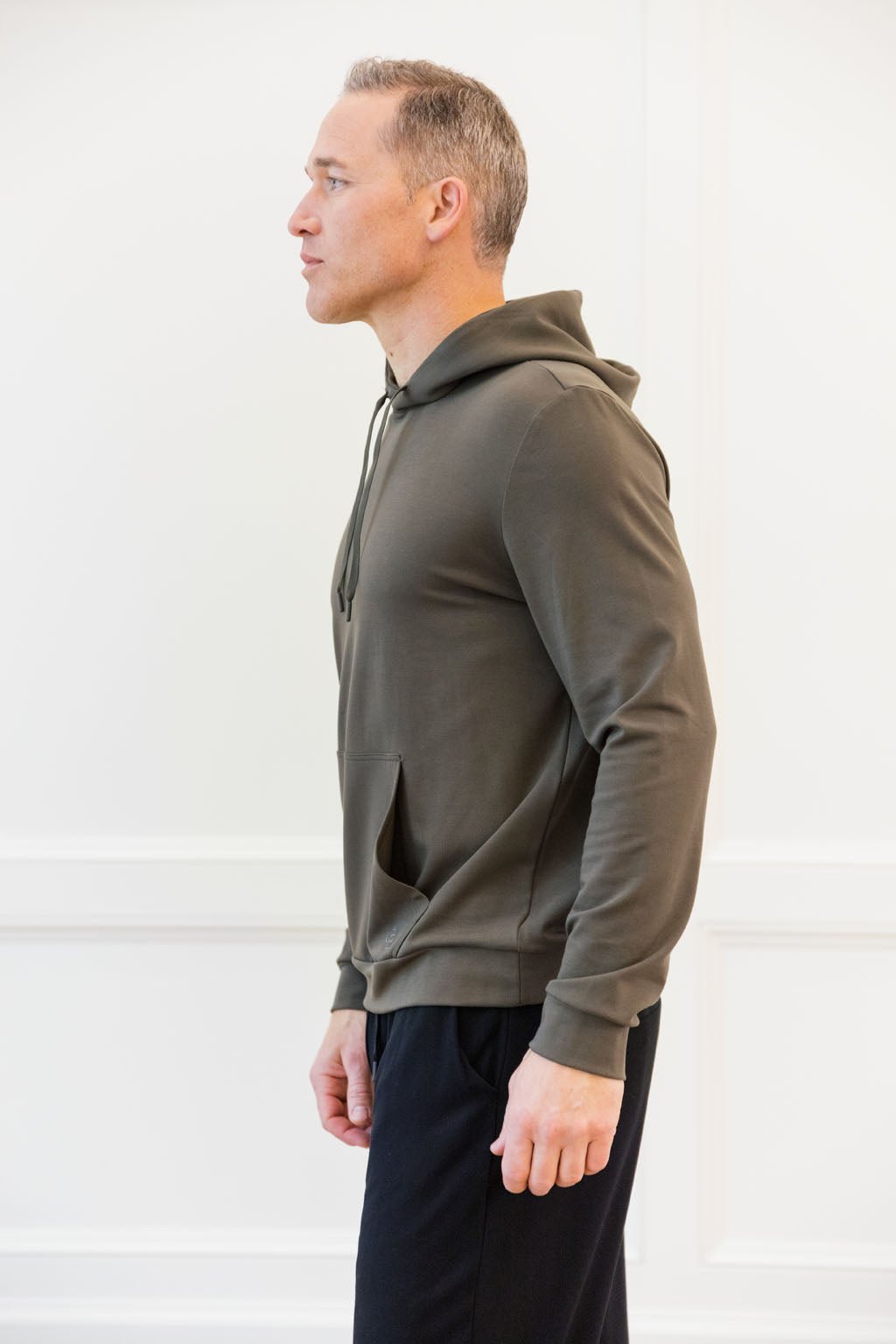 Hunter Bamboo Hoodie worn by man standing in front of white background.
