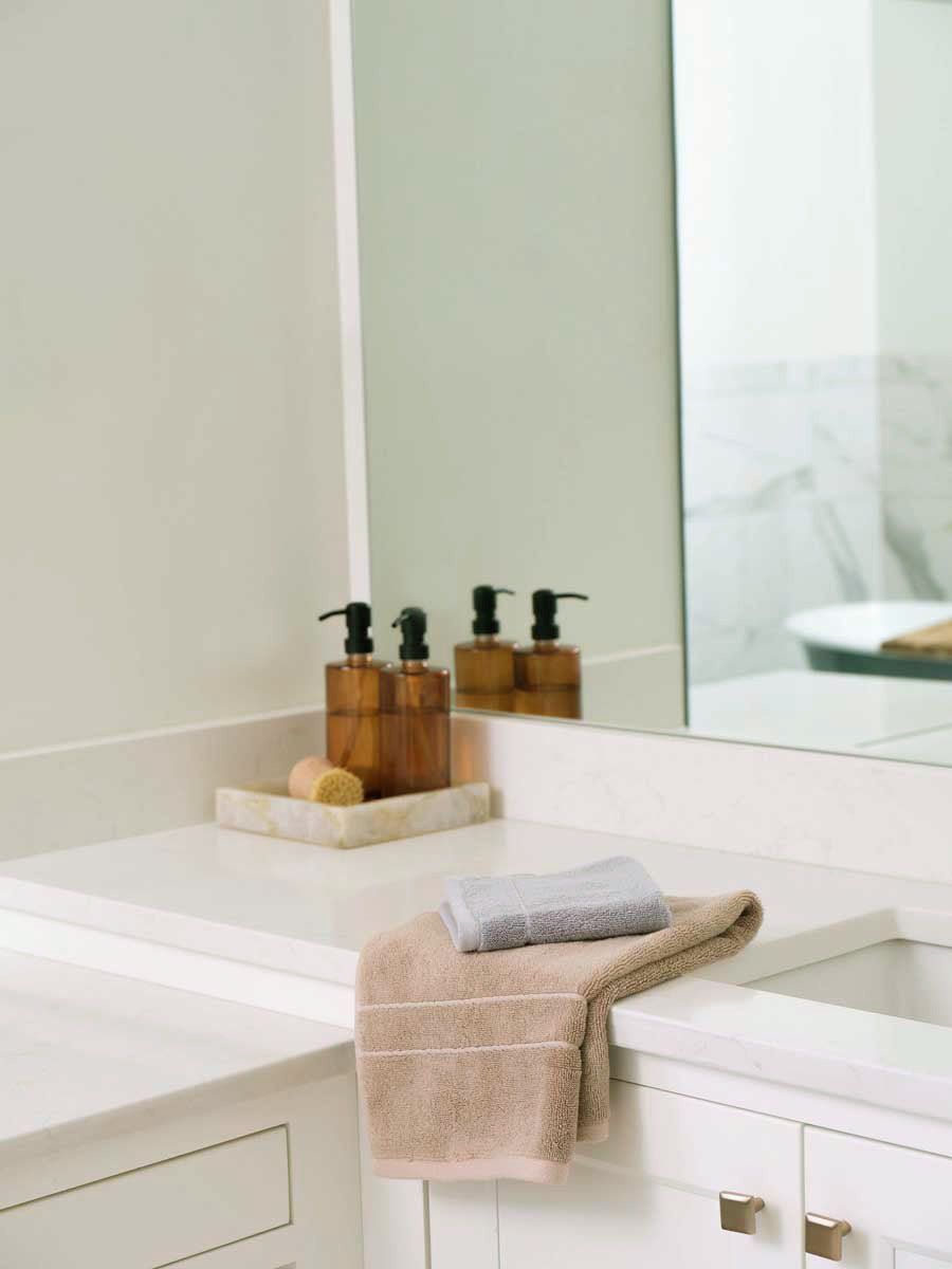 Premium Plush bath towel and wash cloth in the color Sand and Harbor Mist. Photo of Sand, Harbor Mist Premium Plush items taken on a marble sink counter top.