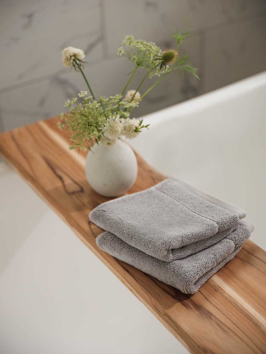 Premium Plush hand towel in the color Harbor Mist. Photo of Harbor Mist Premium Plush hand towel taken in a bathroom with white walls. 