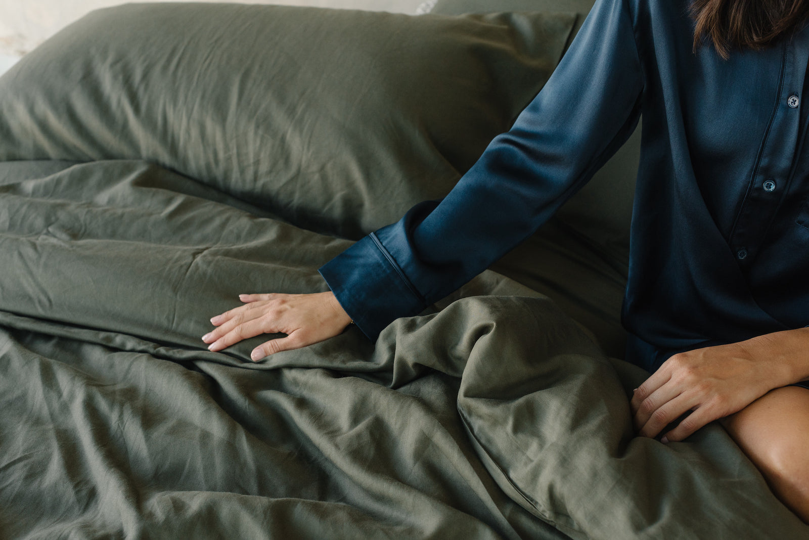 Olive Duvet Cover and comforter resting on a bed.