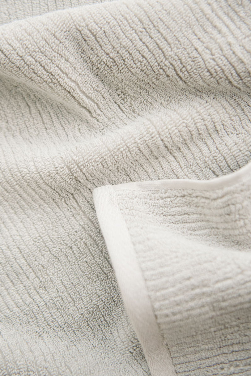 Ribbed Terry Hand Towels in the color Light Grey. Photo of product taken as a close up.