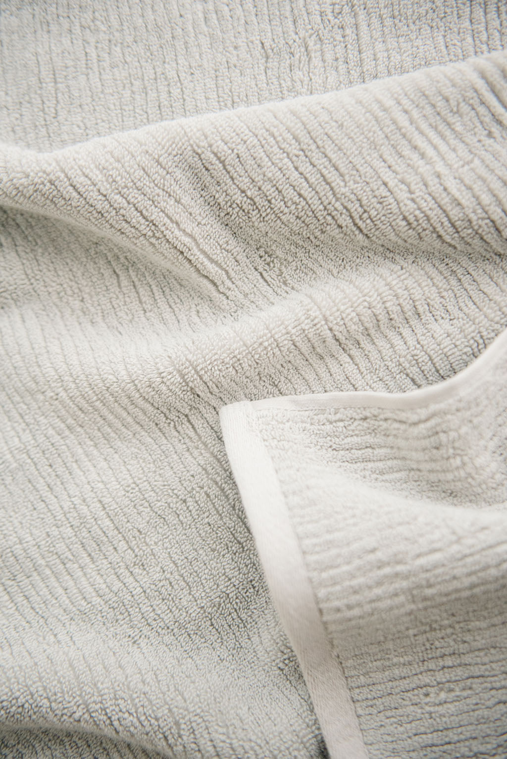Ribbed Terry Hand Towels in the color Light Grey. Photo of product taken as a close up. 