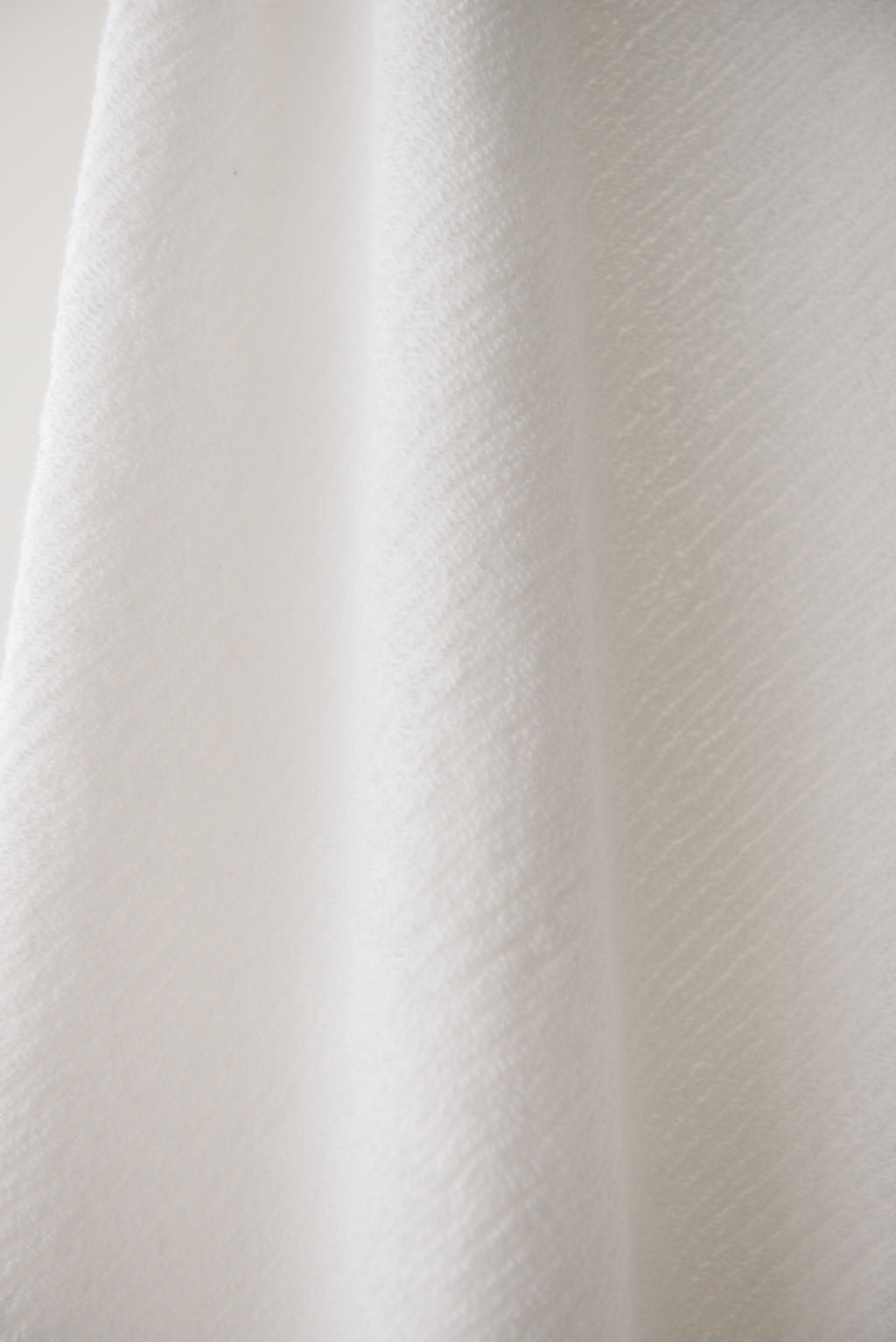 Ribbed Terry Bath Sheets in the color White. Photo of the towel is taken close up.