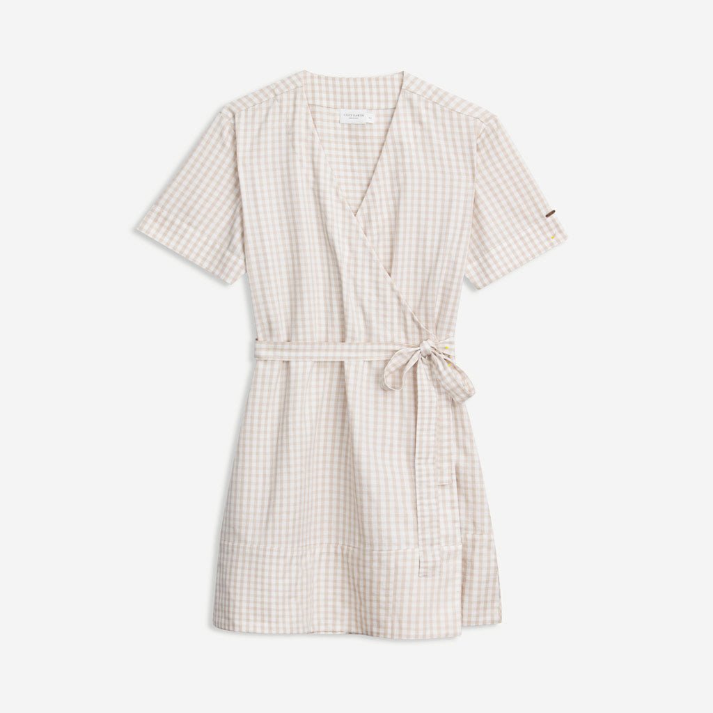 The Women's Cozy Earth Coastal Comfort Wrap Dress by Cozy Earth is a beige and white gingham wrap dress featuring short sleeves, a tie belt at the waist, a V-neckline, and a relaxed fit with a slightly flared hem.