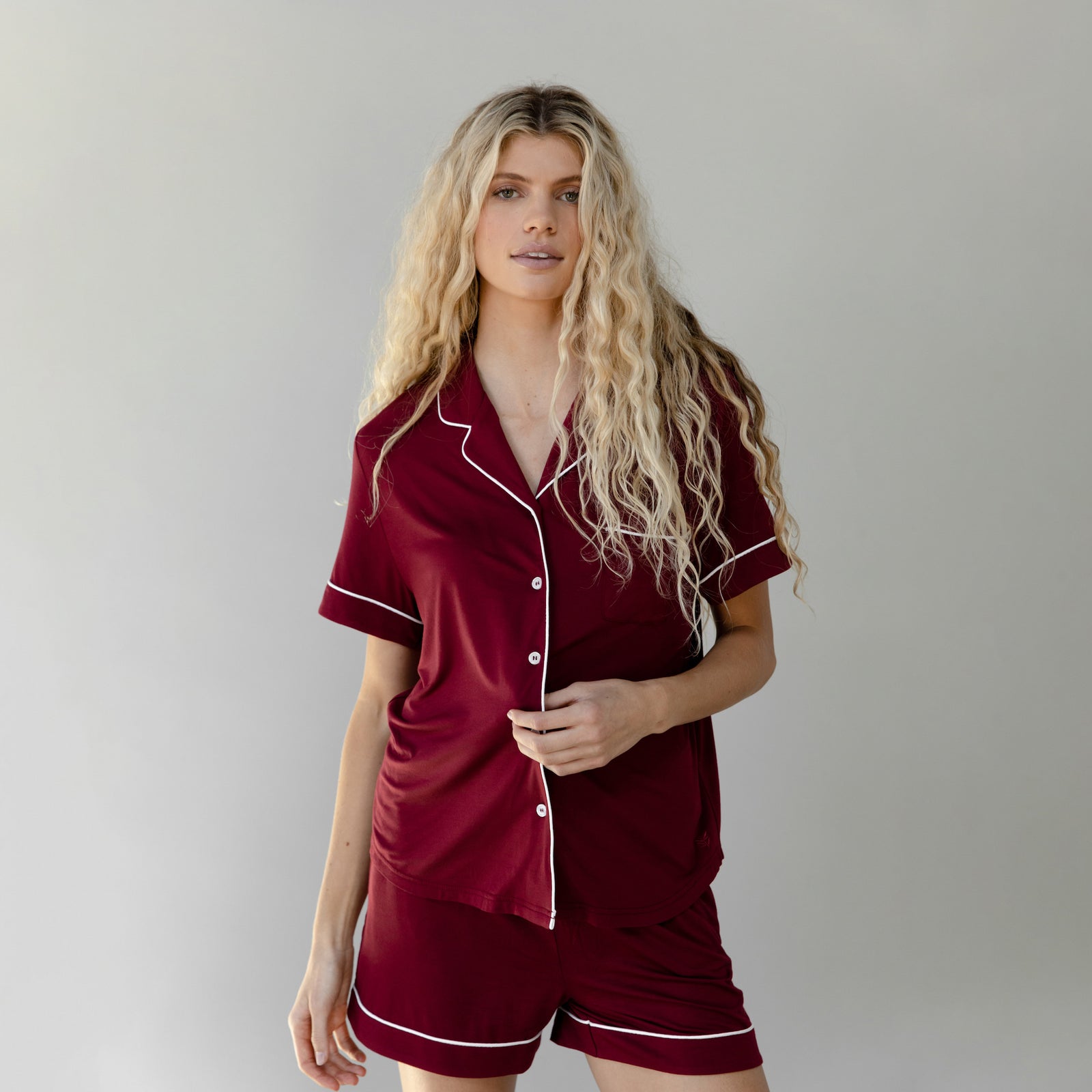 Pomegranate Short Sleeve Pajama Set modeled by a women. The photo was taken in a light setting; showing off the pajamas.