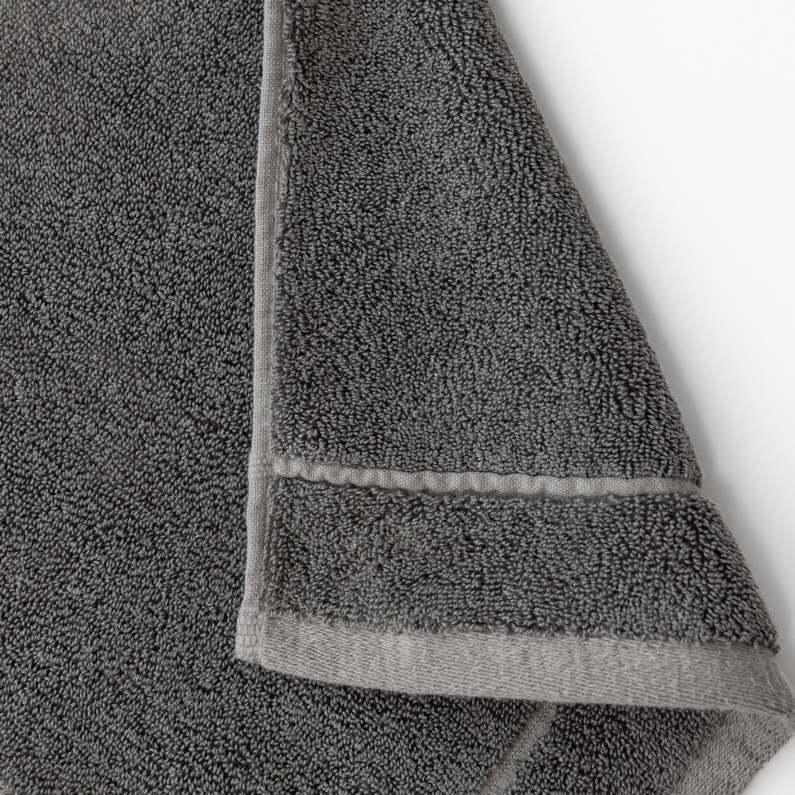 Charcoal Premium Plush Bath Towel. Photo of Premium Plush Bath Towels taken on a white background showing only the corner of the towel. 
