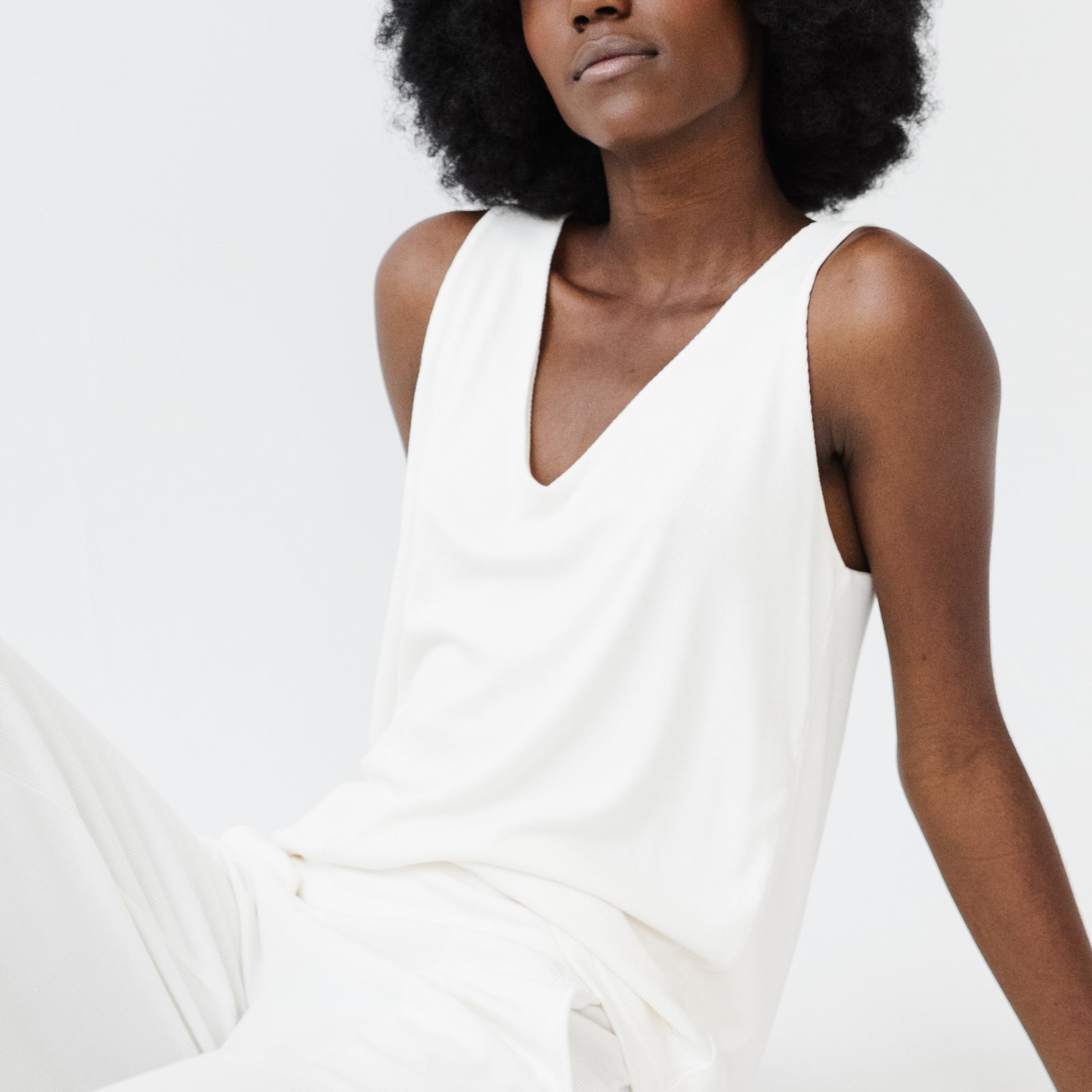 Woman wearing Cozy Earth white Bamboo Rib-Knit V-Neck Tank Lounge tank