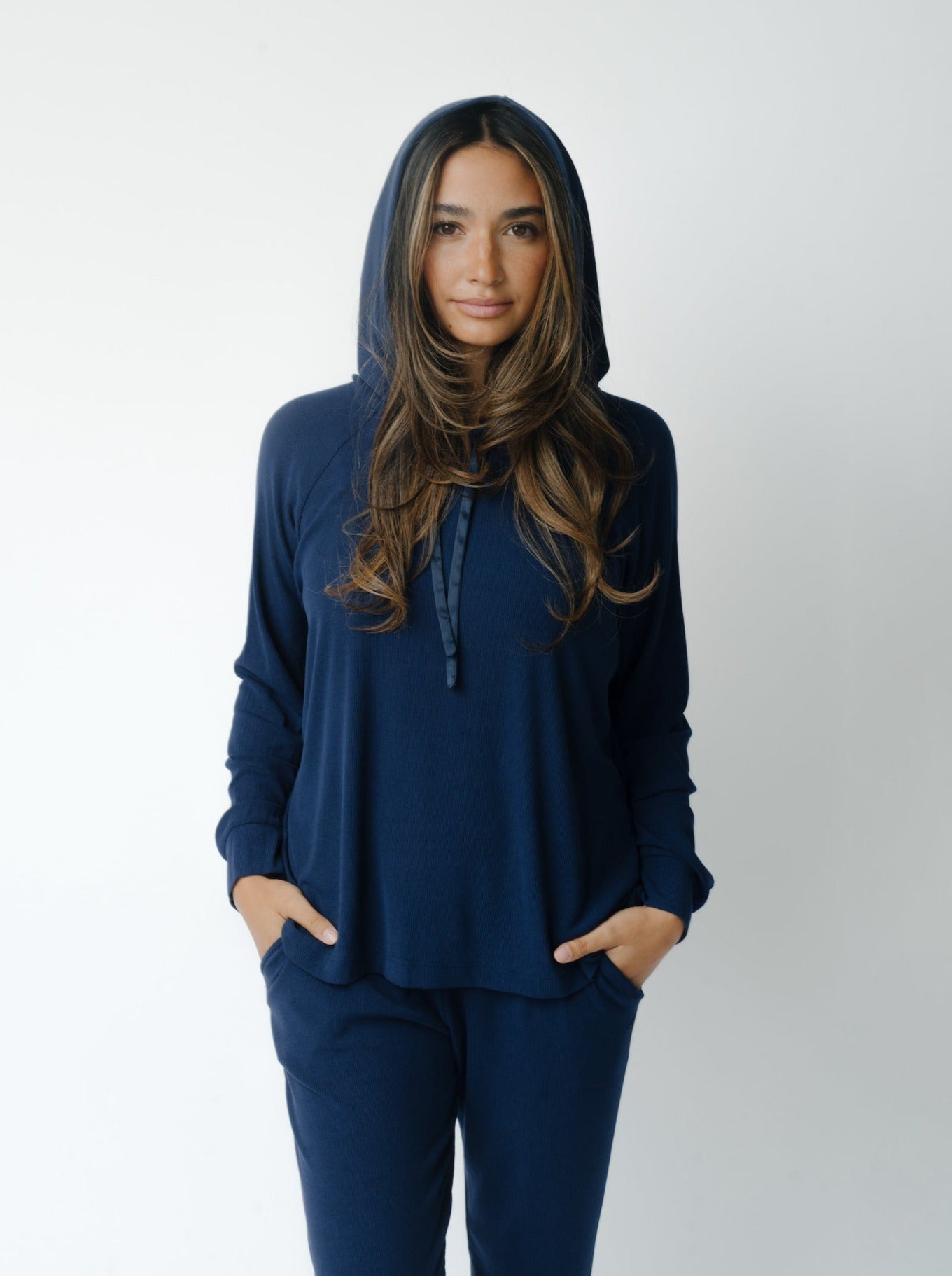 Woman wearing a Cozy Earth Rib Knit Hoodie in blue against a white background