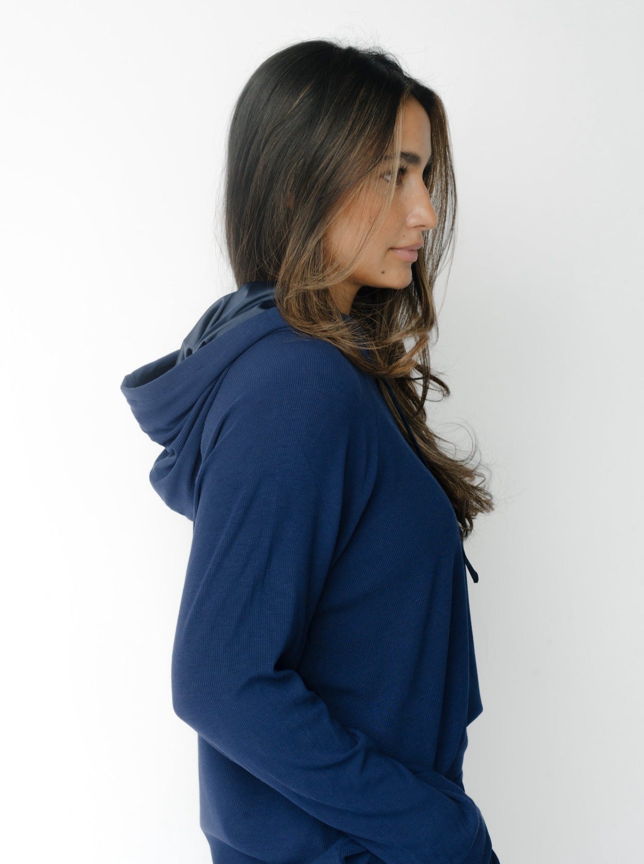 Woman wearing a Cozy Earth Rib Knit Hoodie in blue against a white background