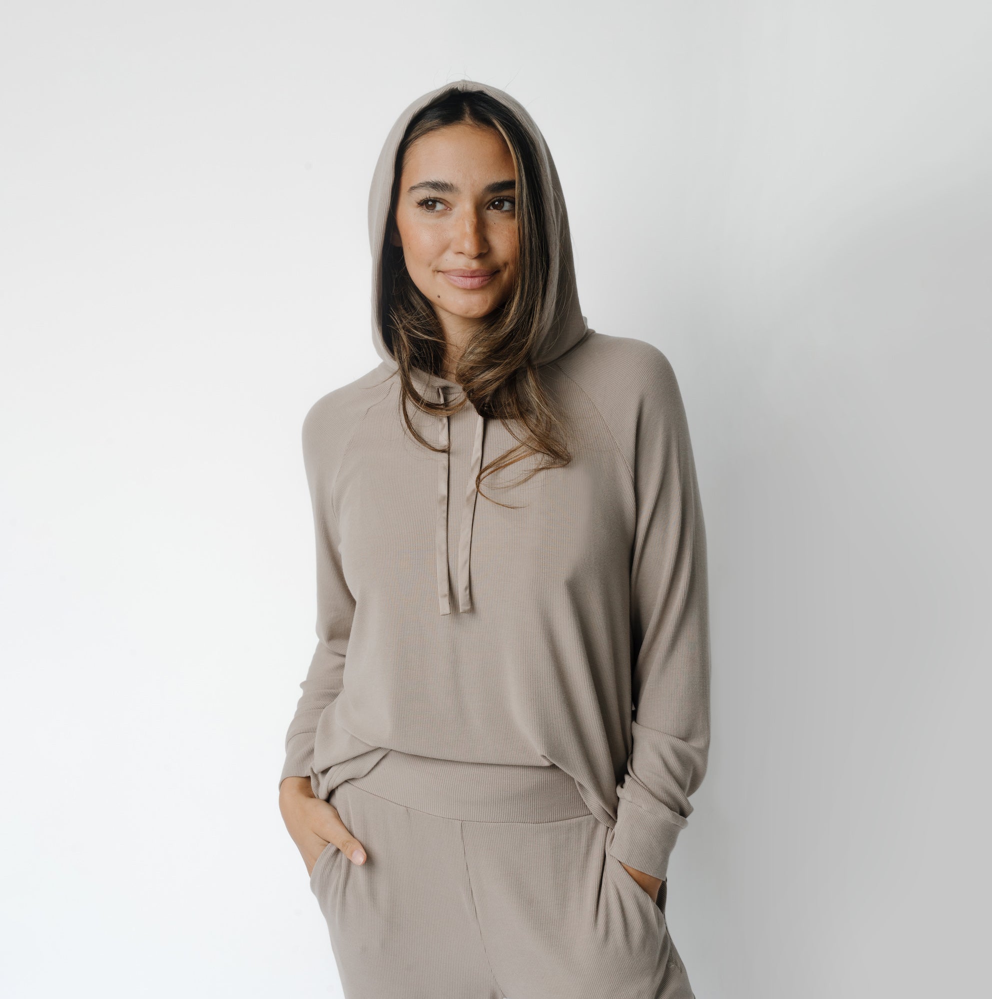 Woman wearing a Cozy Earth Rib Knit Hoodie in tan against a white background |Color:Suede