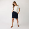 Person wearing a Cozy Earth Brushed Bamboo Patch Pocket Skirt in navy on a white background |Color:Navy