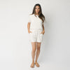 Woman wearing a white t-shirt and white Cozy Earth Brushed Bamboo Shorts shorts on a plain background |Color:Ivory