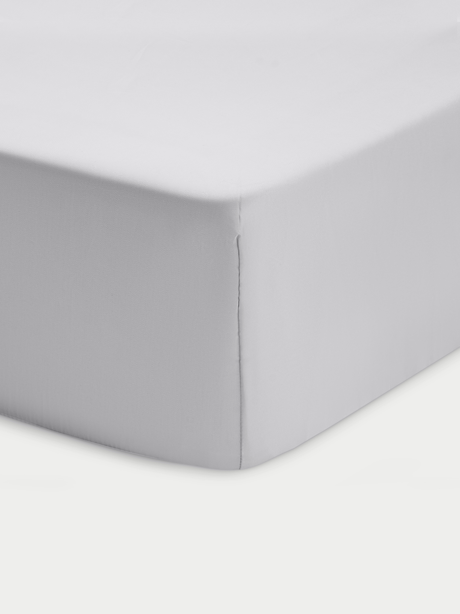 Corner of light grey crib sheet with white background 