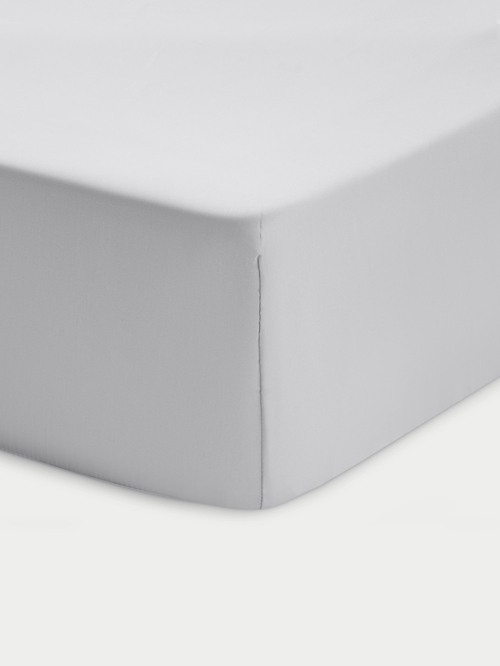 Corner of light grey crib sheet with white background