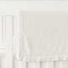 White Cloud Knit Baby Blanket draped over white crib |Color:White