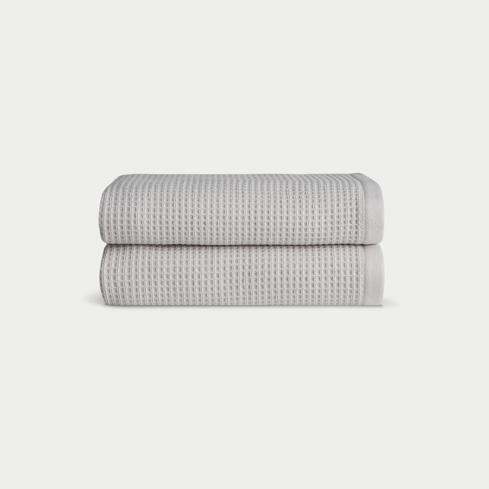 Light Grey Waffle Hand Towel set neatly folded. The photo was taken with a white background.