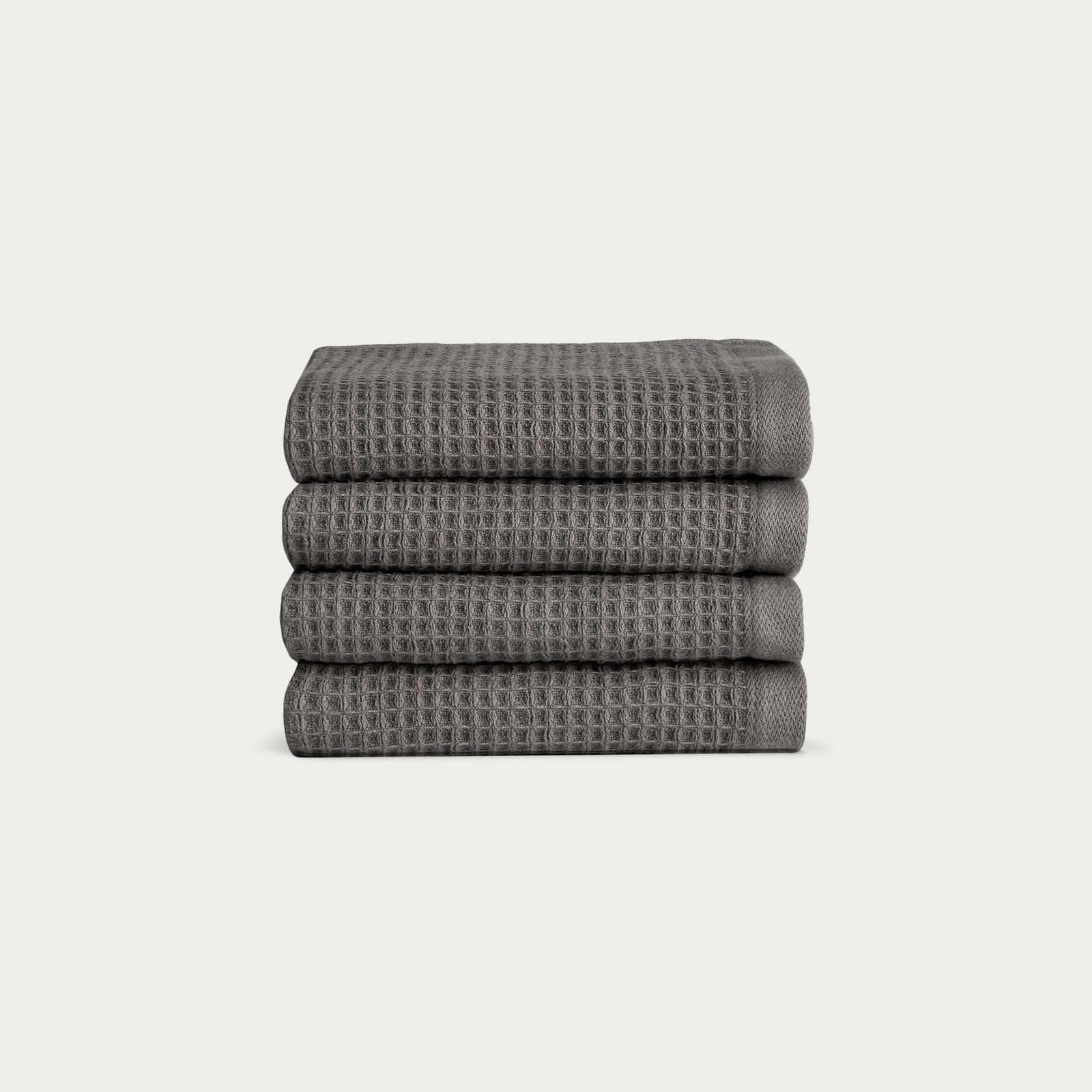Charcoal Waffle Wash Cloths neatly folded. The photo was taken with a white background. 