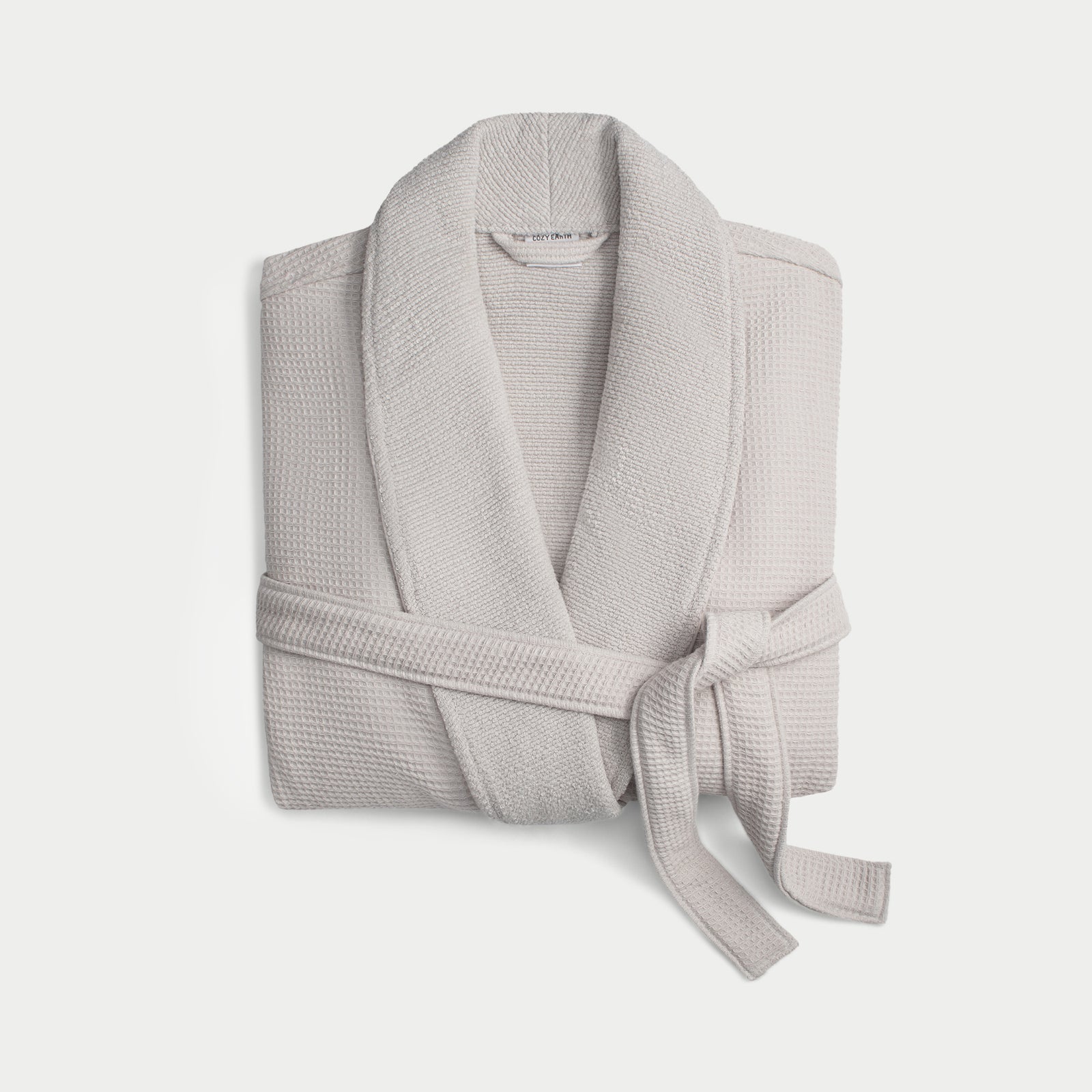 Light grey bamboo waffle knit robe shown neatly folded with a white background. 