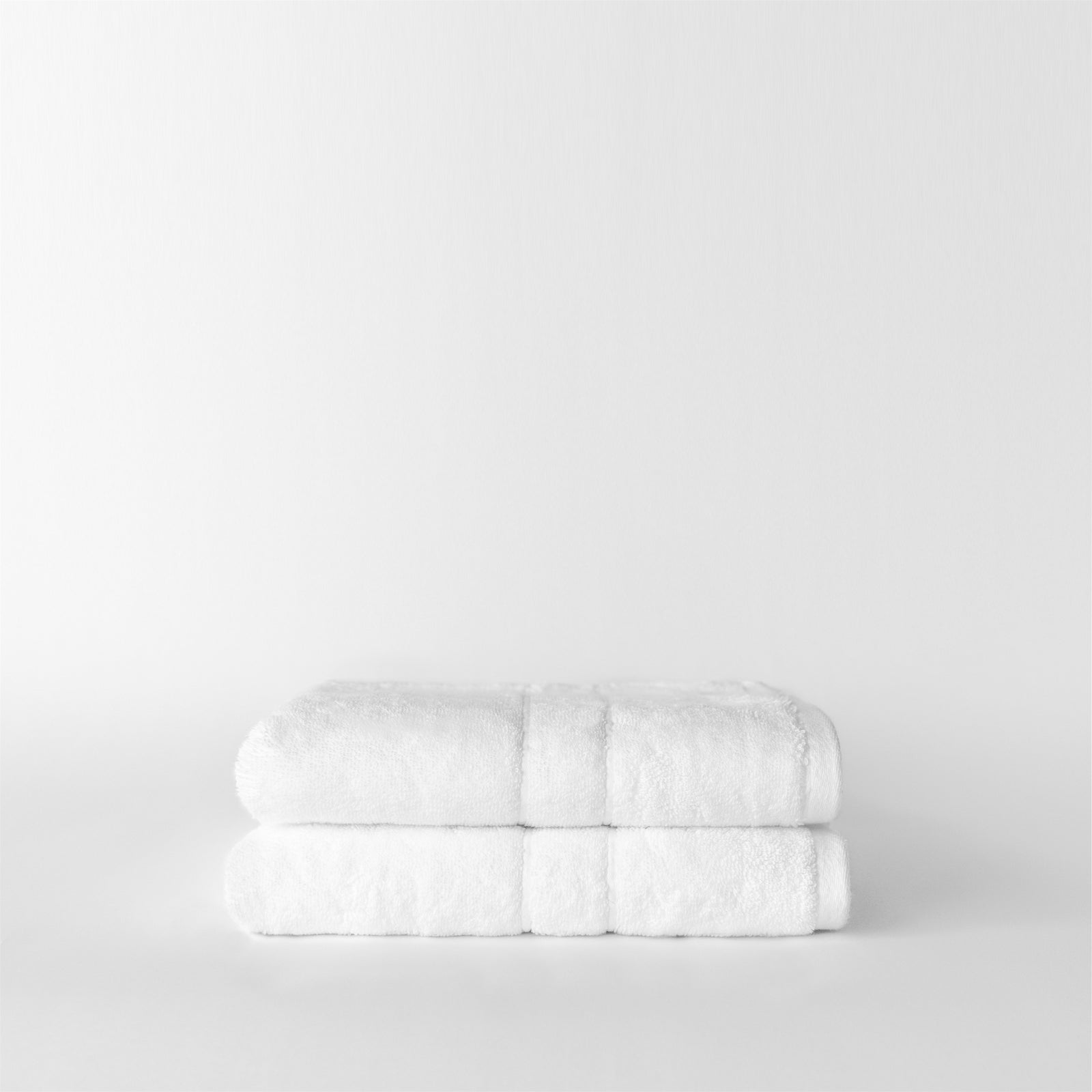 Premium Plush Hand Towels in the color white. Photo of Complete Premium Plush Hand Towel taken with white background