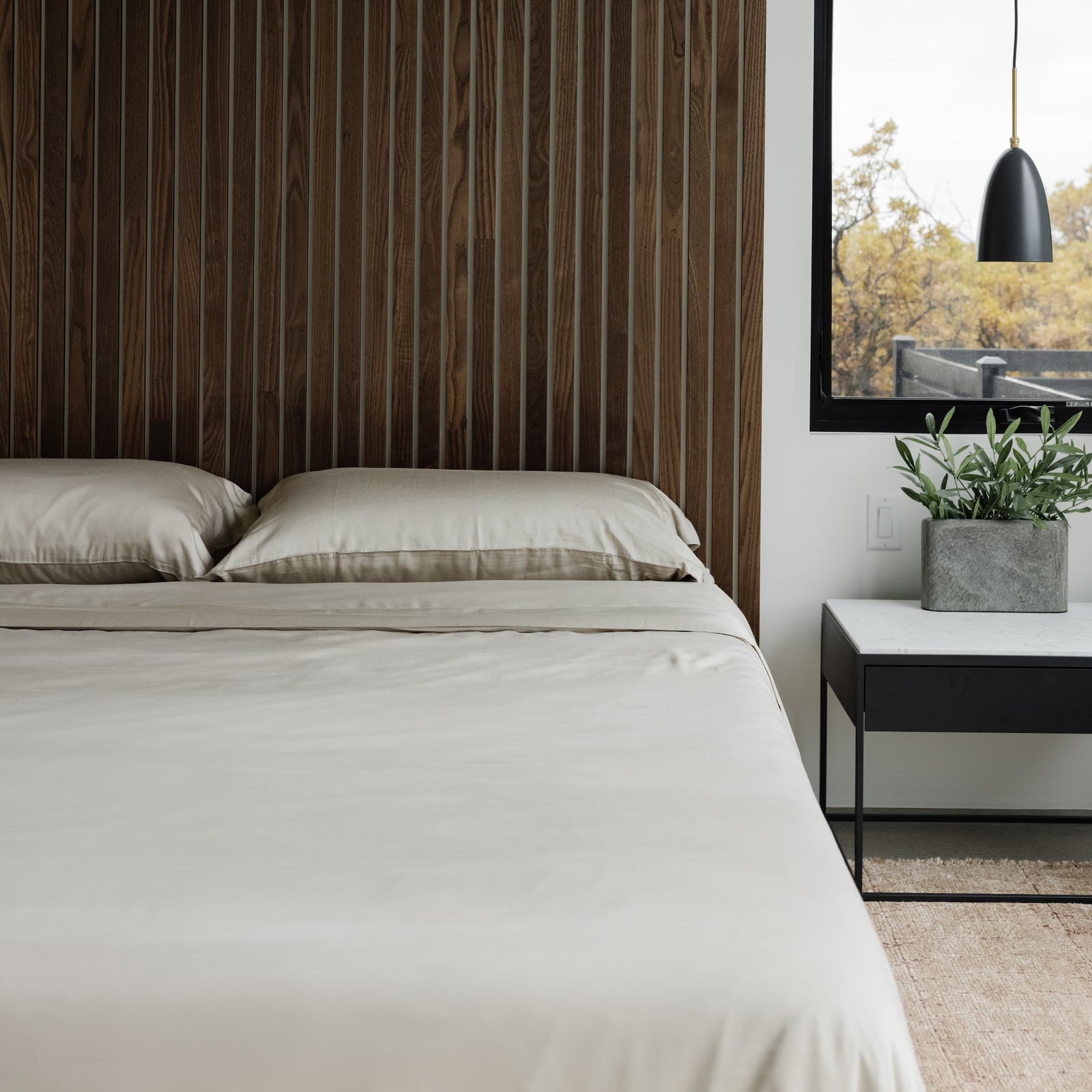 Driftwood pillows and duvet cover on a made bed