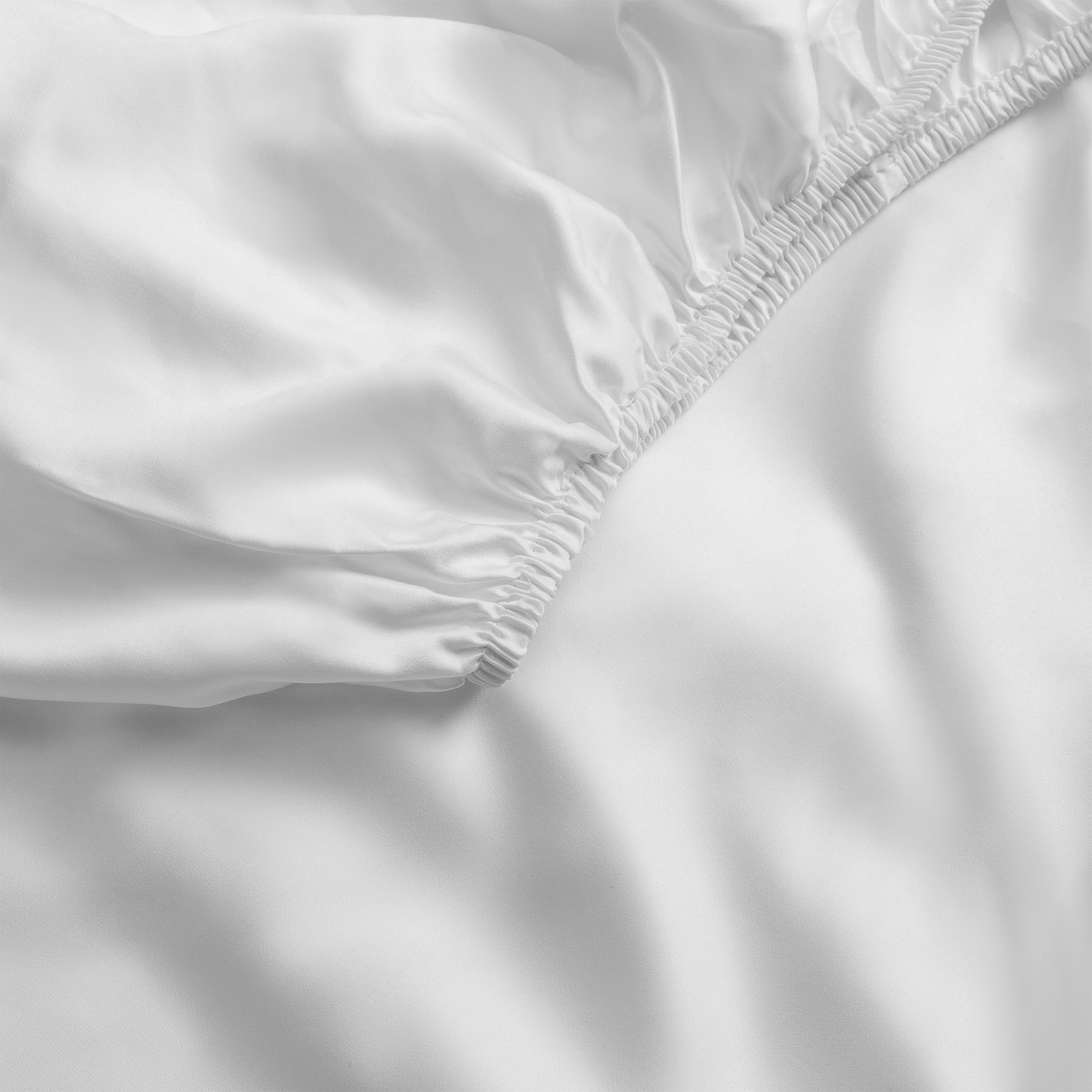 Close up of light grey fitted sheet 