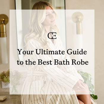 A woman sits on a bathroom counter wearing Cozy Earth Luxe Bath Robe