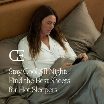 a woman lies in bed with grey sheets