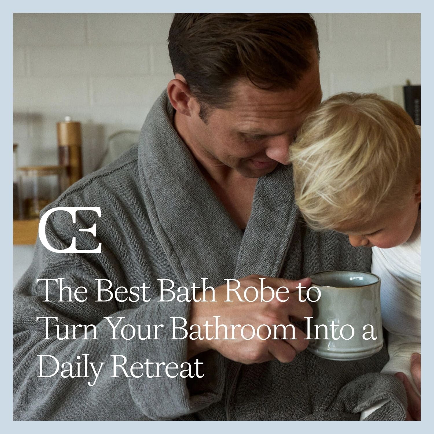 a man wearing a grey Luxe Bath Robe holds a child and looks into a coffee cup