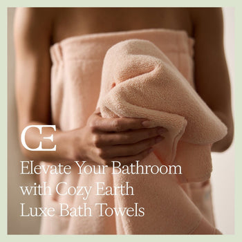A woman holds a Cozy Earth Bath Towel while wearing a bath wrap