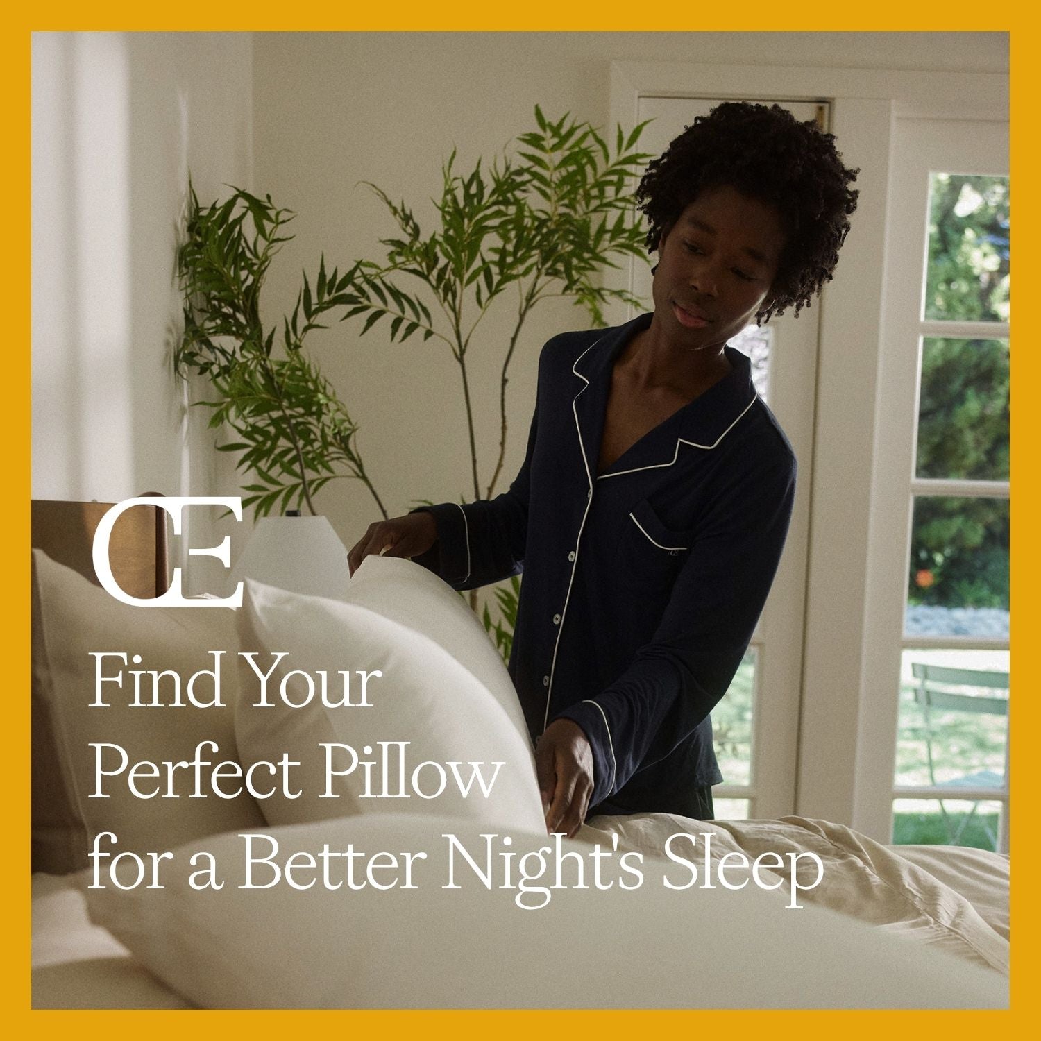 a woman sets pillows on a bed
