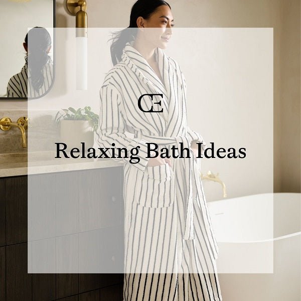 Woman standing in bathrobe in next to vanity and tub
