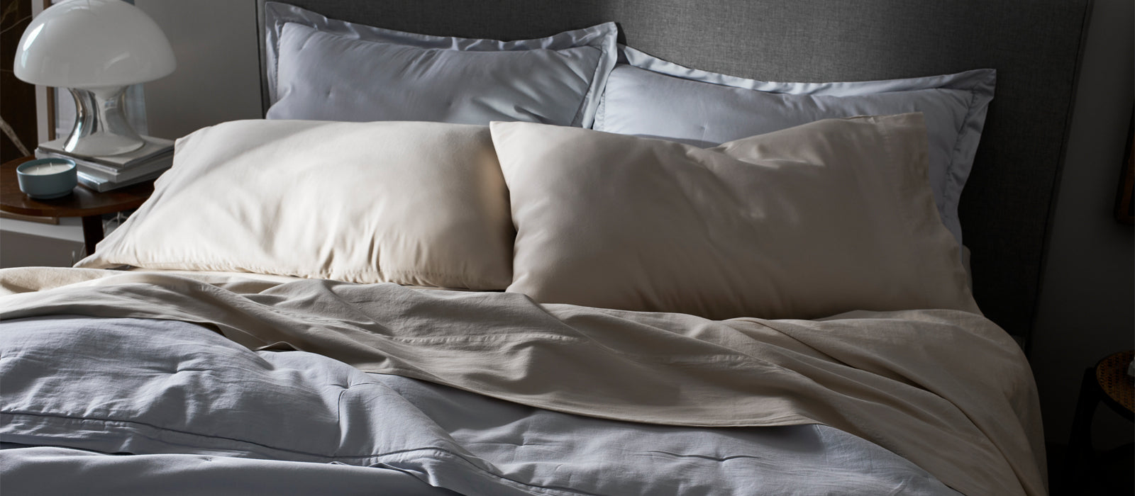 A bed featuring blue and tan Cozy Earth Soft-Wash Cotton sheets and duvet cover