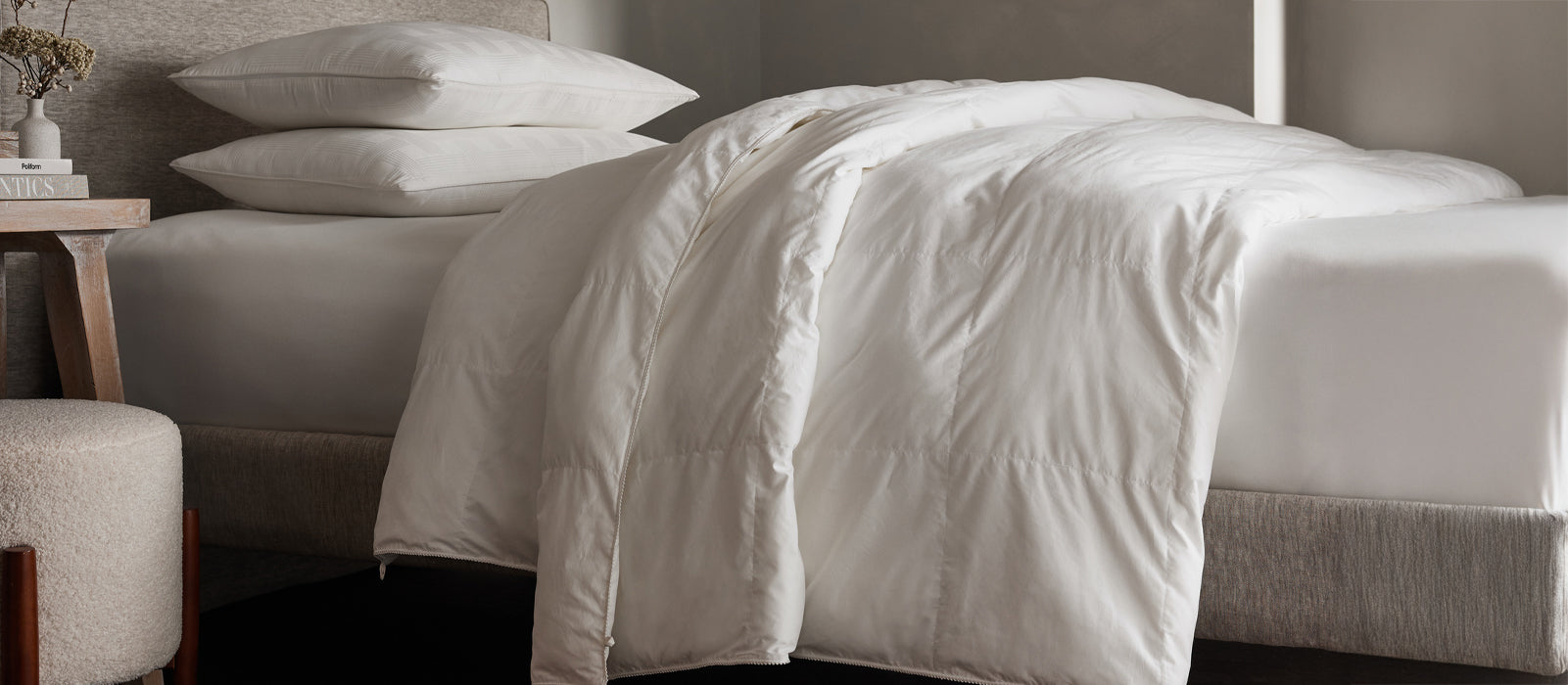 a bed featuring Cozy Earth Down Alternative Comforter draped over sheets