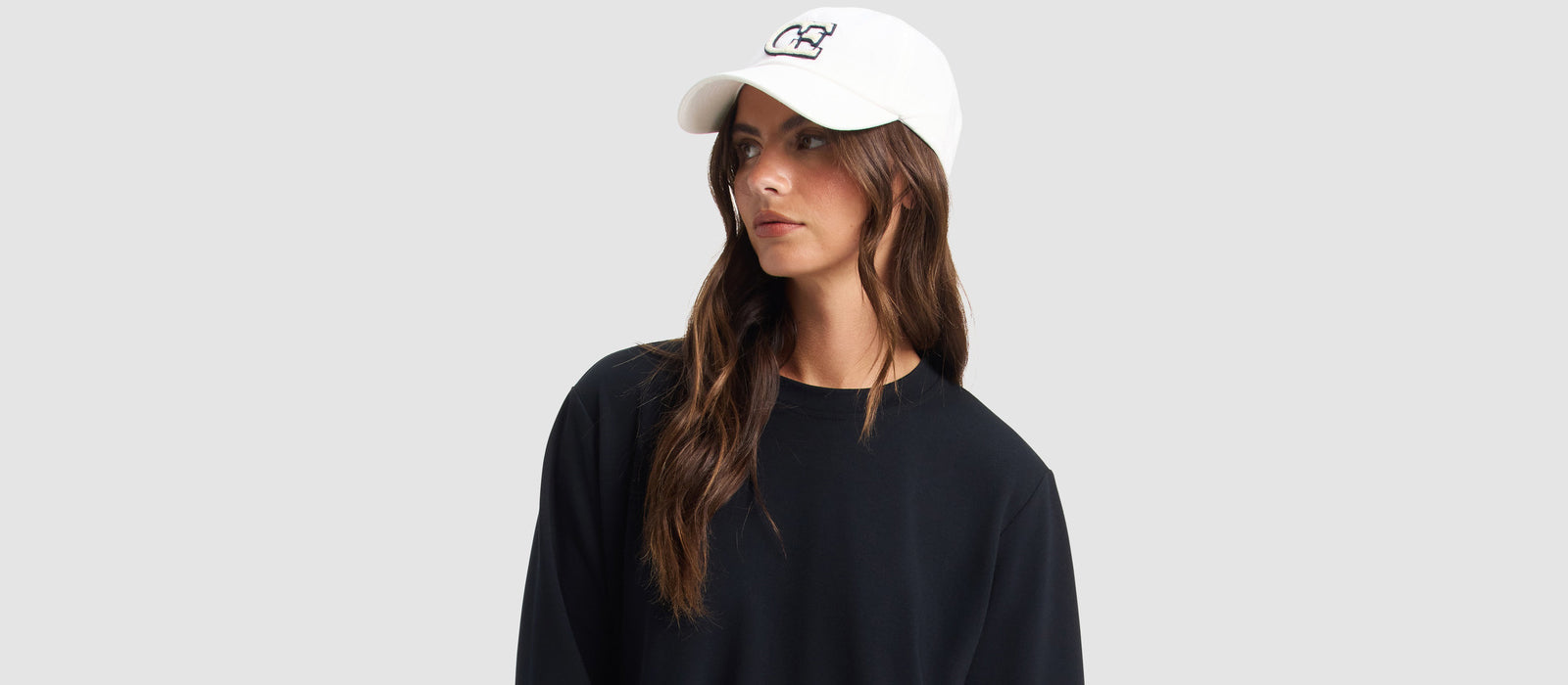 a woman wears a white Cozy Earth hat