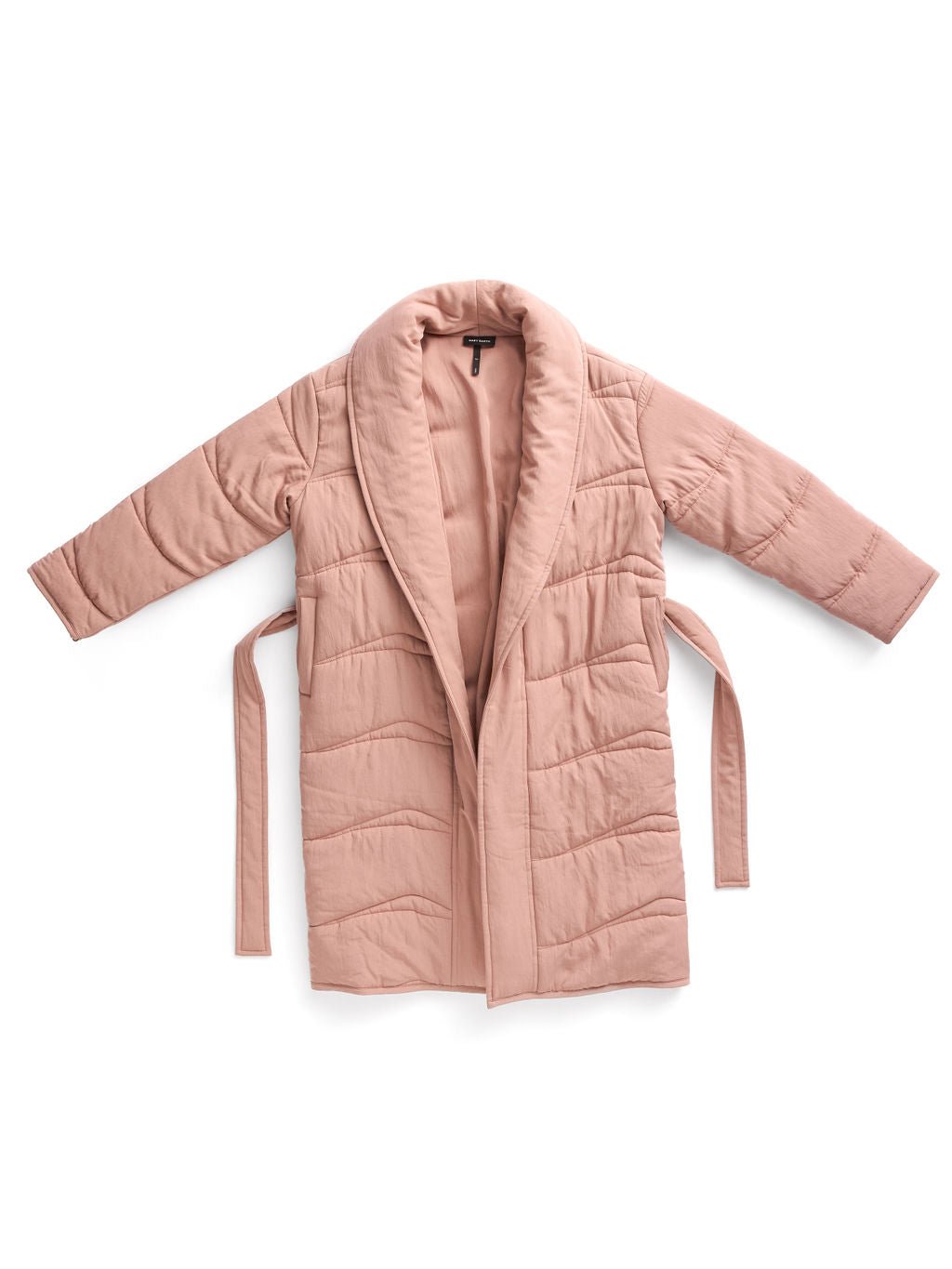 The Women's Quilted House Coat by Cozy Earth is light pink with a shawl collar and long sleeves. It features a belted closure with loose ties on each side and is laid flat on a white background. 