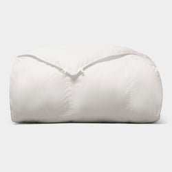 The Cozy Earth Down Alternative Comforter is neatly folded and fluffy, displayed against a plain light gray background. |Filling:Standard