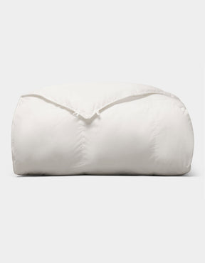 The Cozy Earth Down Alternative Comforter is neatly folded and fluffy, displayed against a plain light gray background. |Filling:Standard