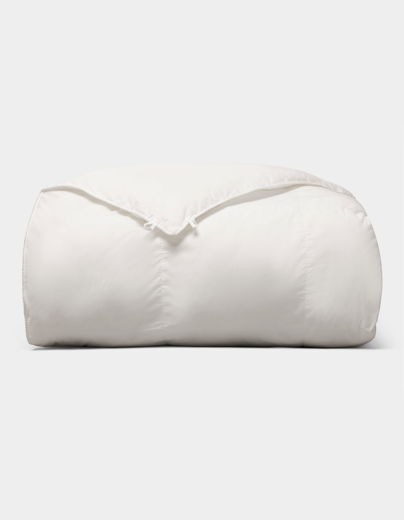 The Cozy Earth Down Alternative Comforter is neatly folded and fluffy, displayed against a plain light gray background.