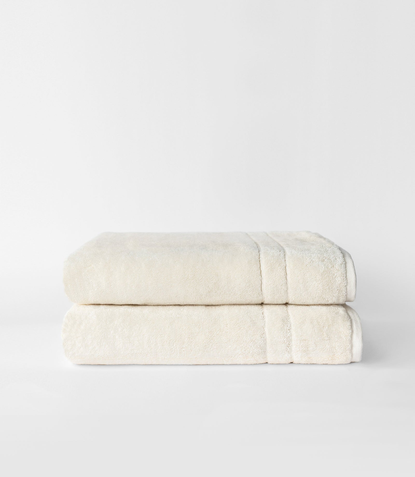 Premium Plush Bath Sheets in the color creme. Photo of bath sheets taken with white background 