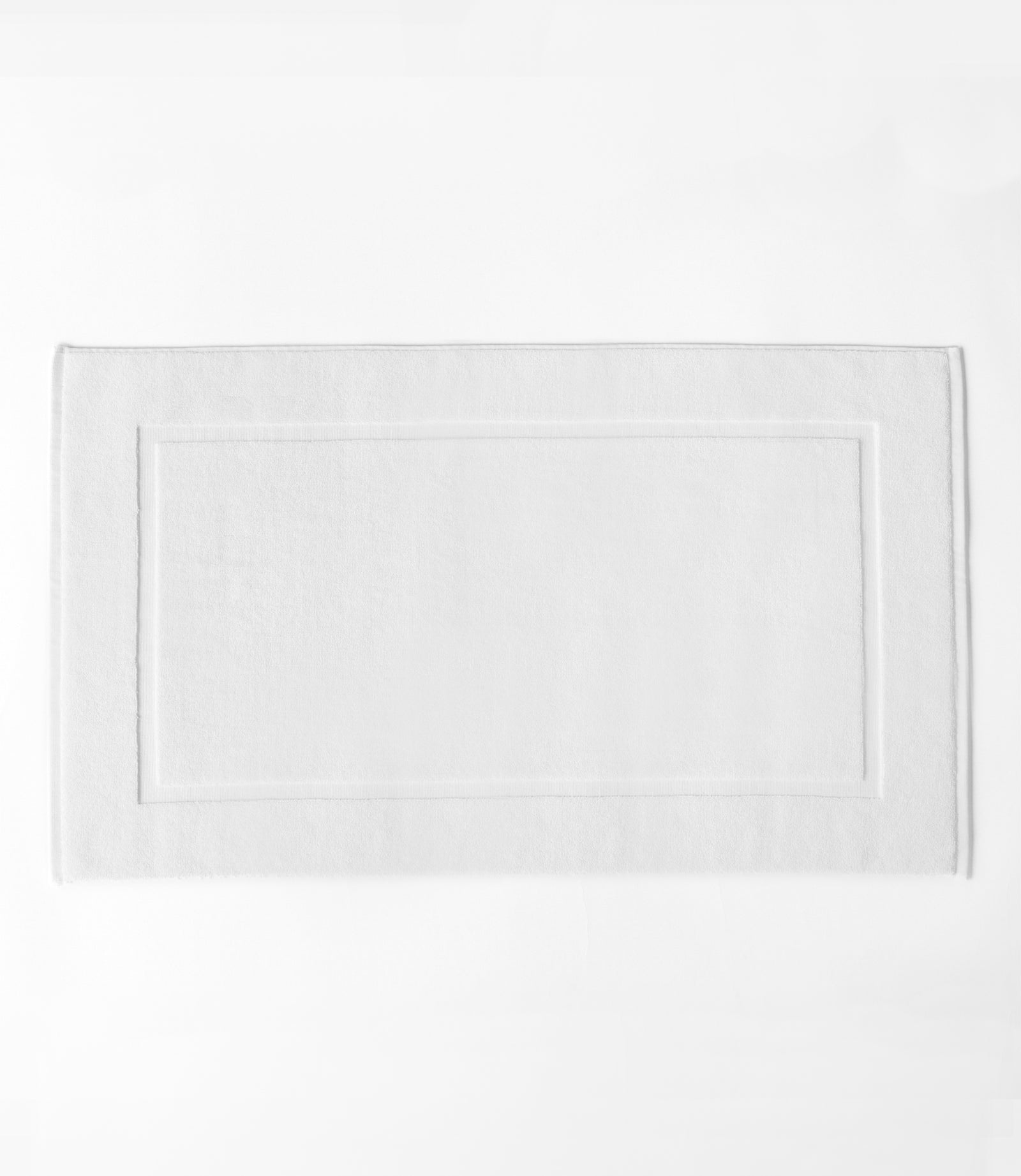 White Premium Plush Bath Mat resting on white background.