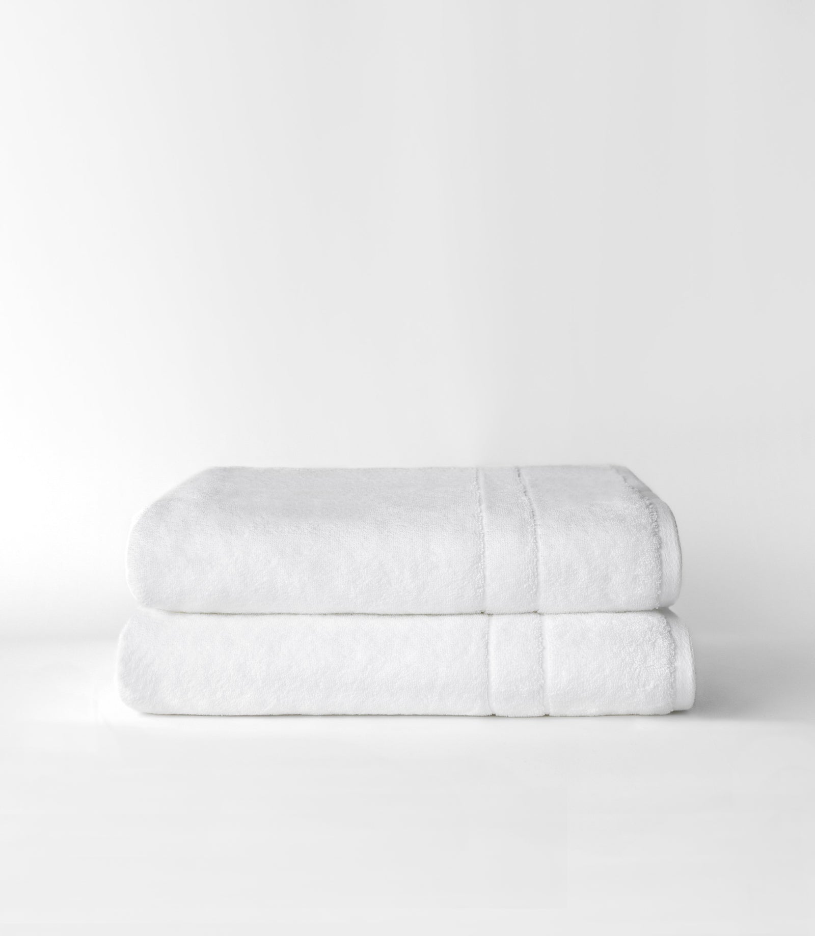 Premium Plush Bath Sheets in the color white. Photo of bath sheets taken with white background 